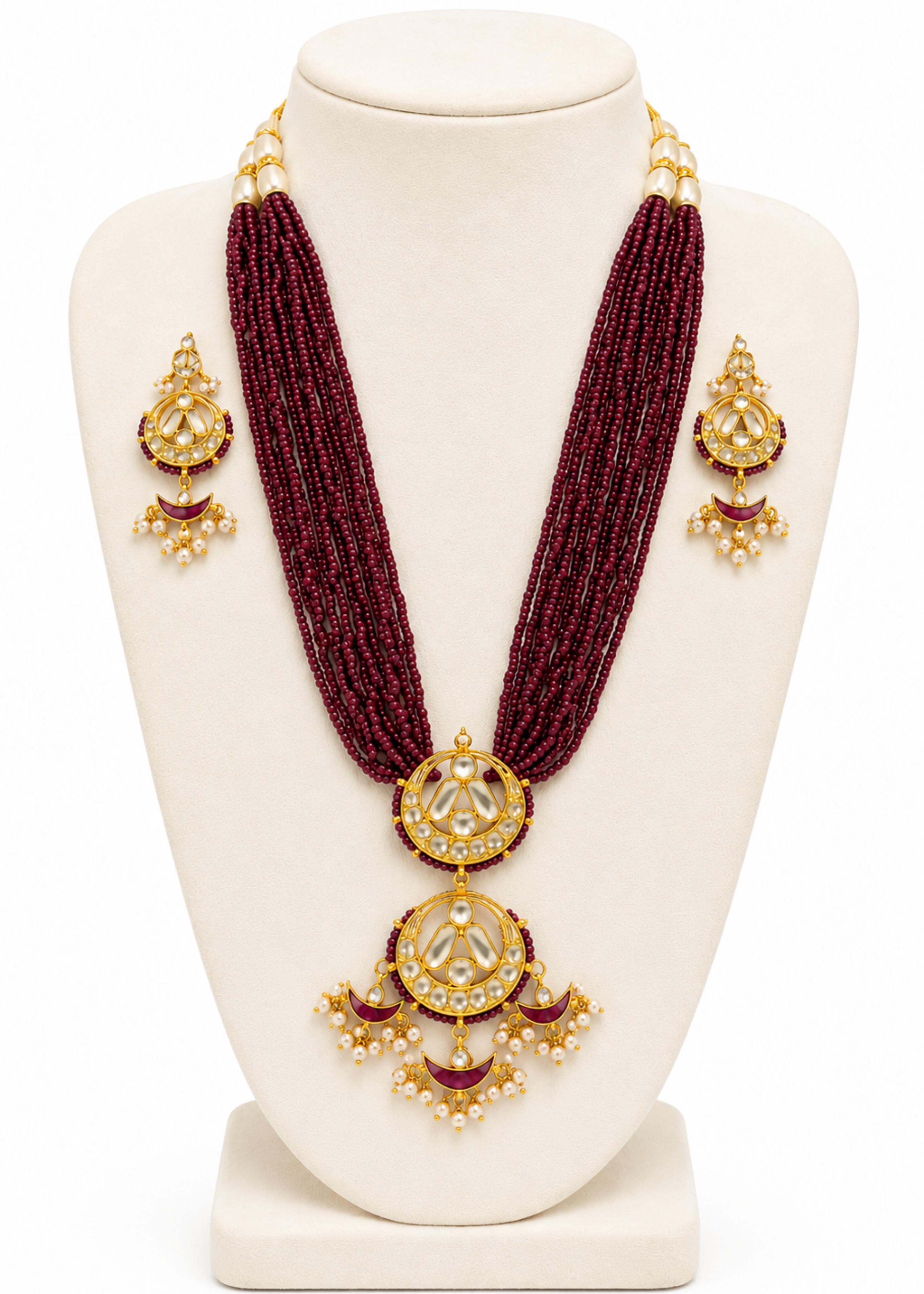 Maroon beaded necklace with gold pendants on a white mannequin bust