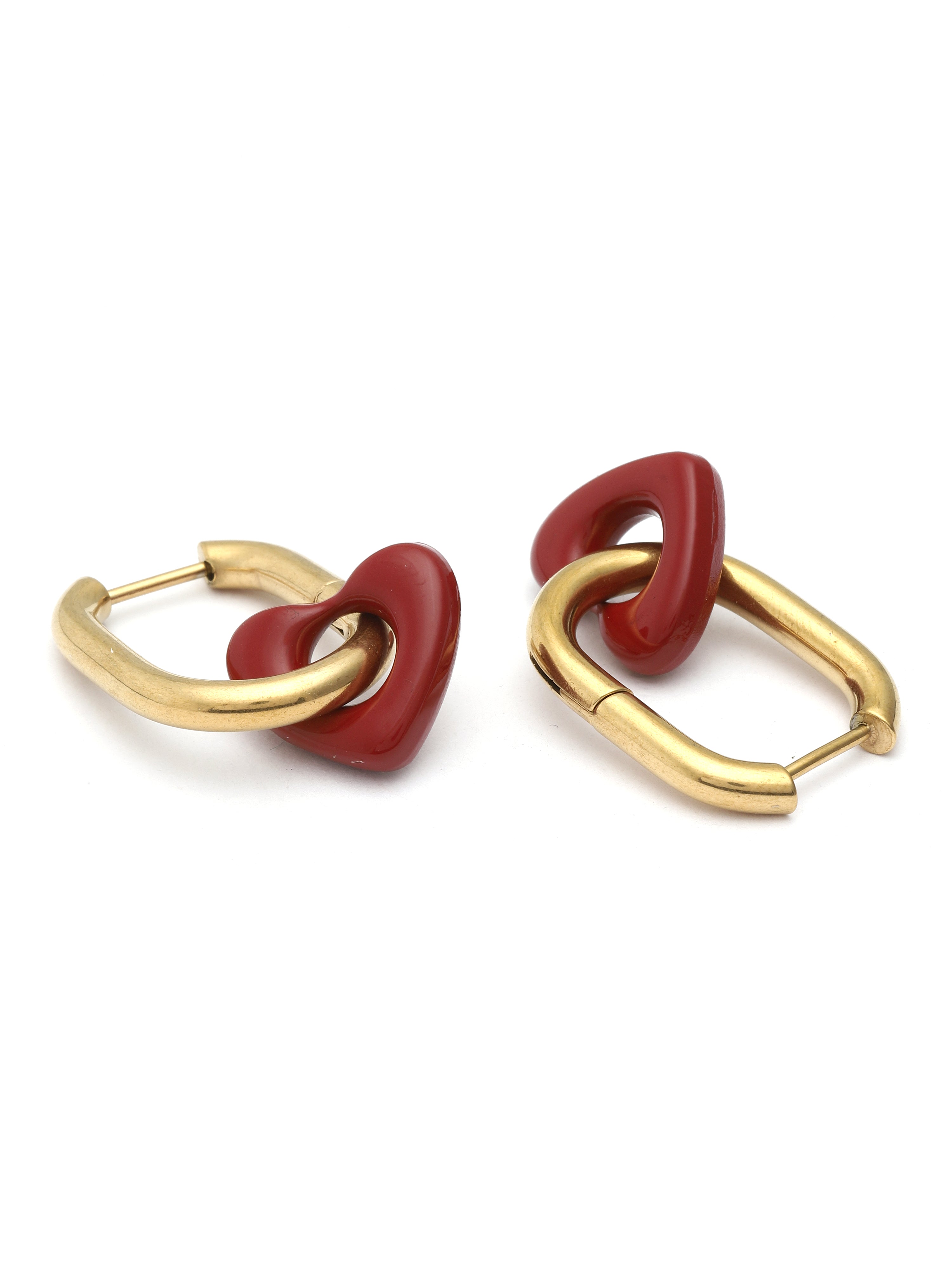 Pair of earrings with gold loops and red stones on a white background