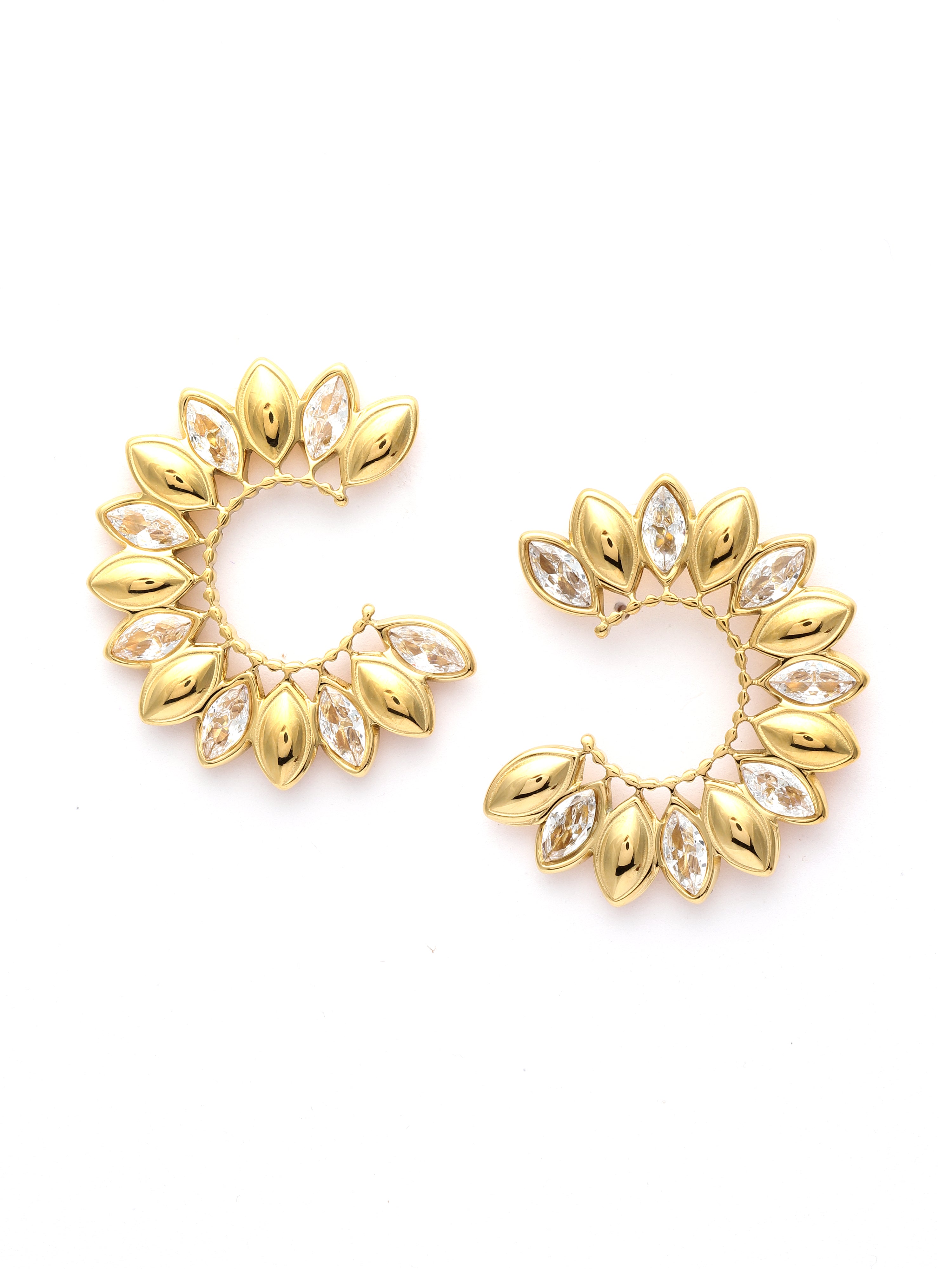 Gold earrings with leaf-like designs on a white background