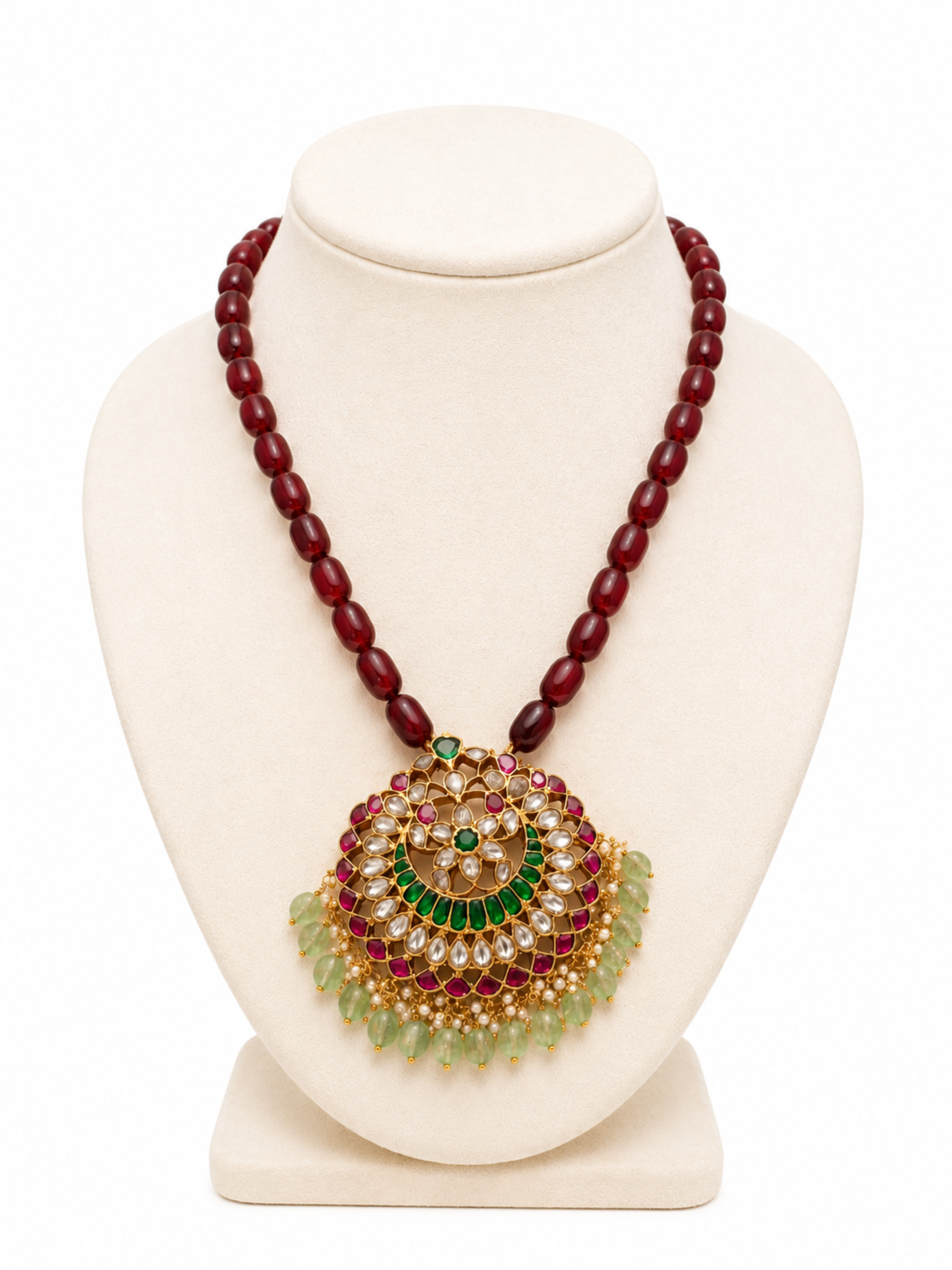 Jewelry necklace with a large, ornate pendant on a white background