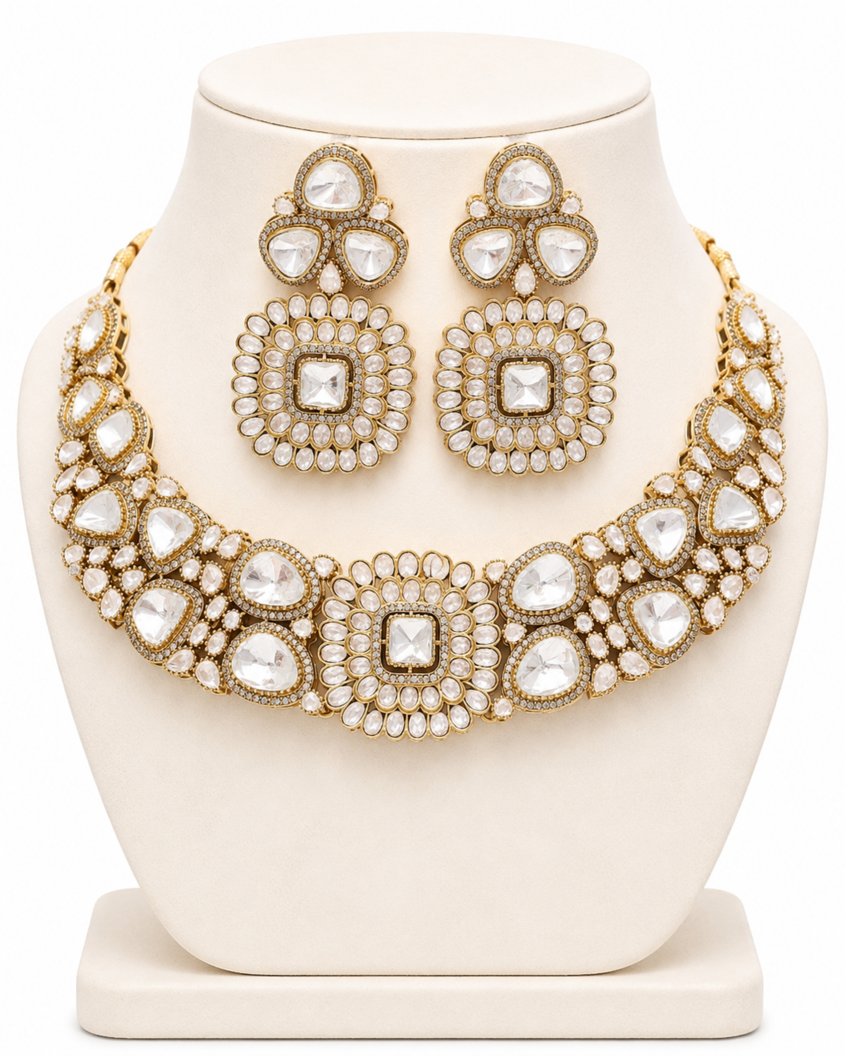 Ornate gold and white jewelry set on a white stand