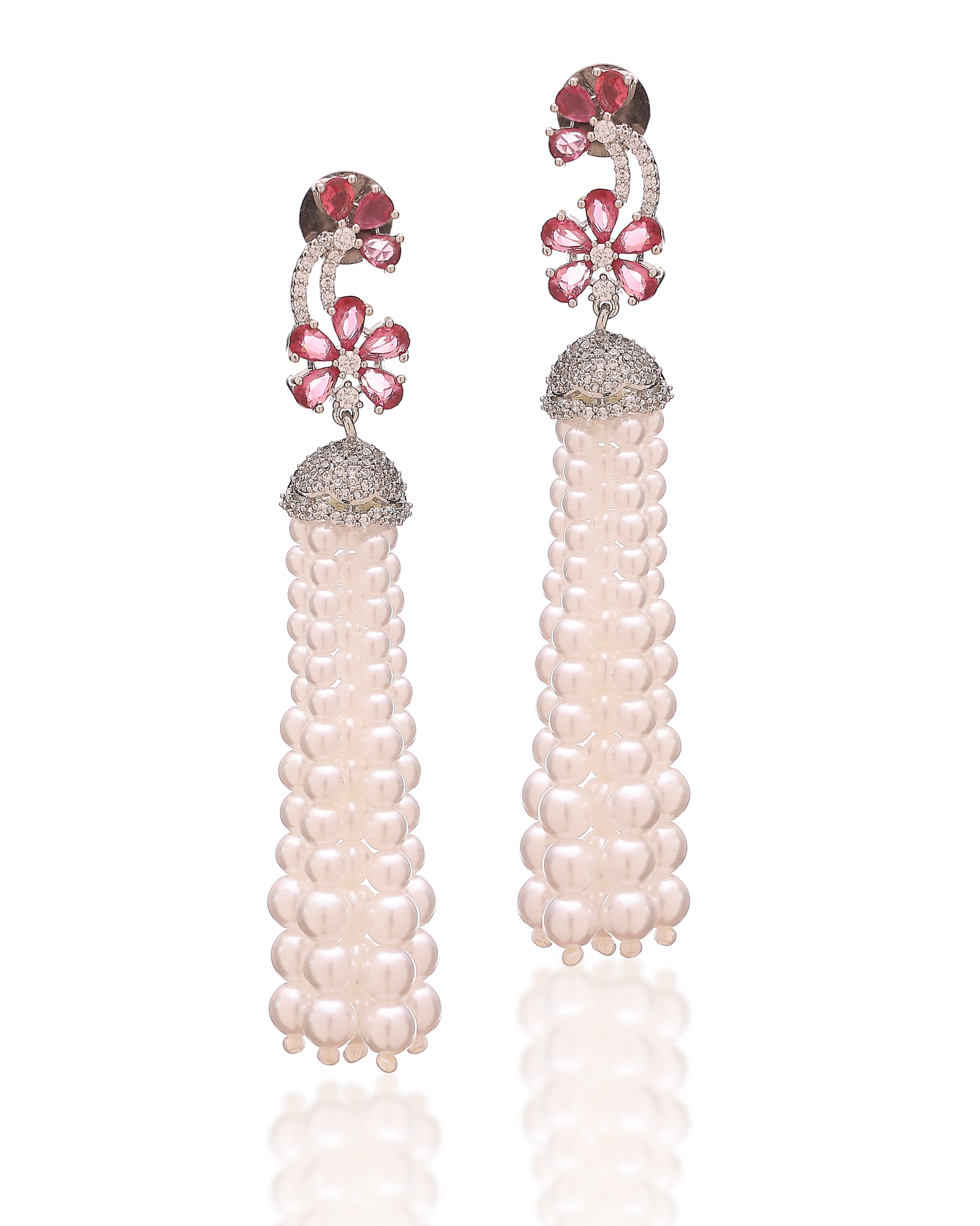 Pair of pearl earrings with pink gemstones on a white background