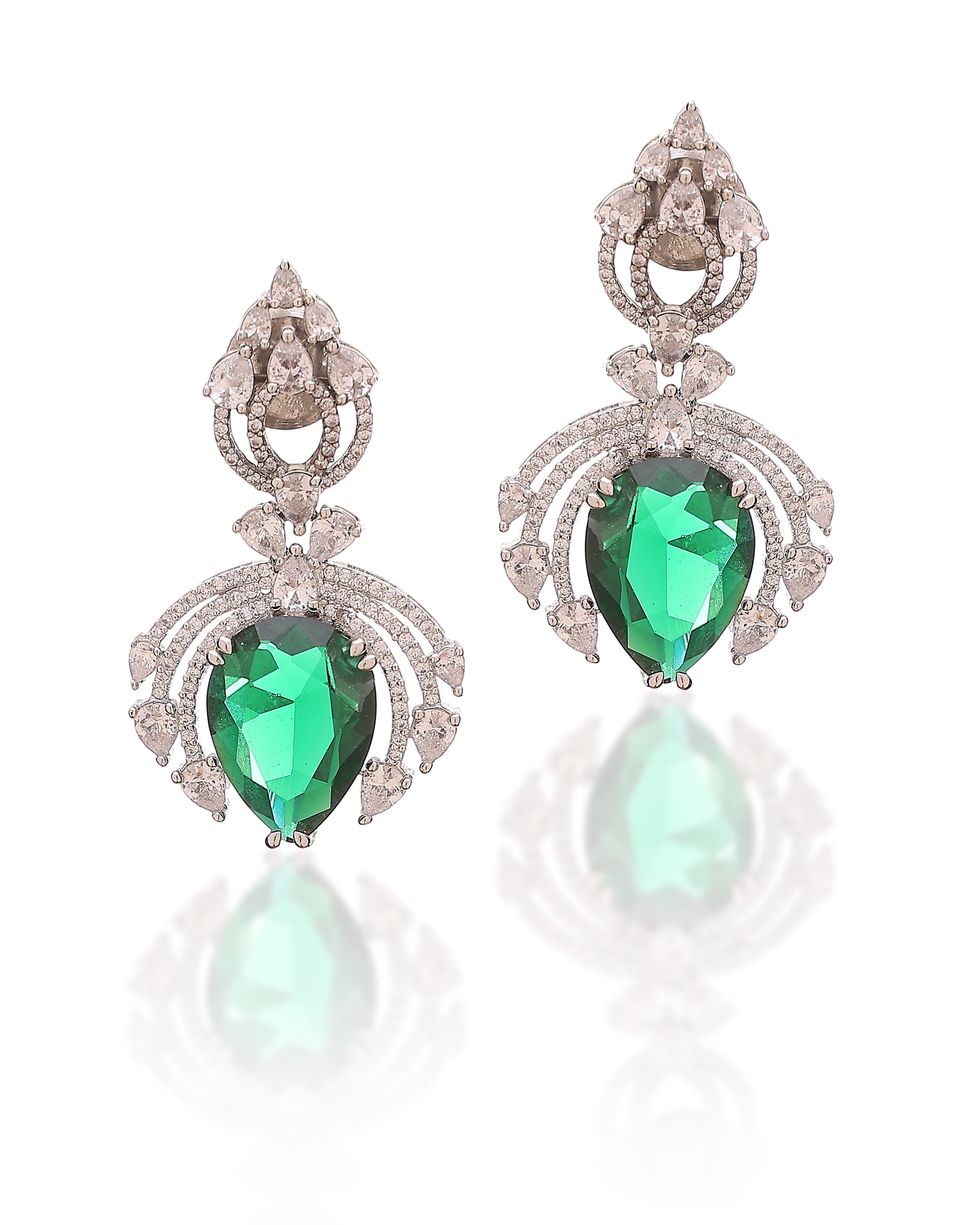 Pair of earrings with green gemstones and silver detailing on a white background
