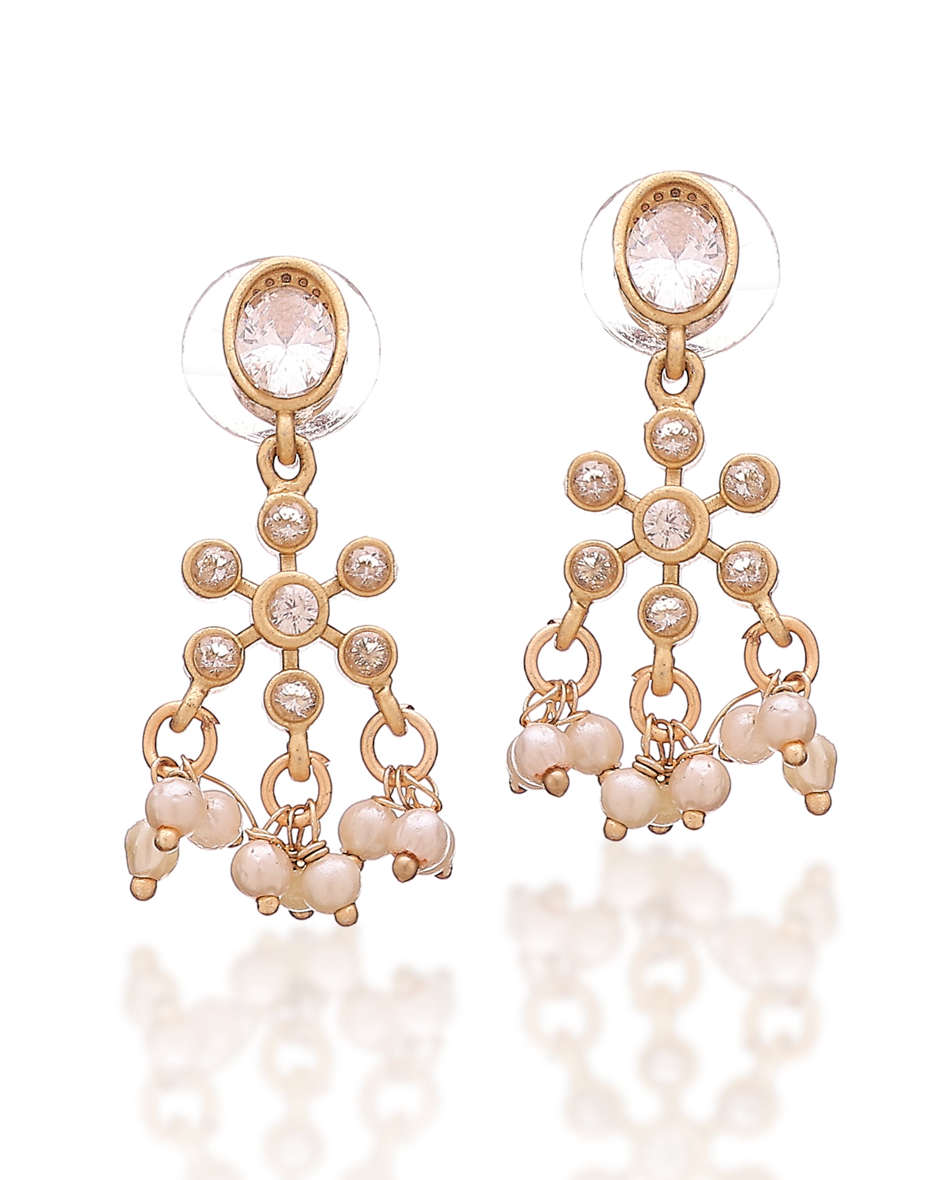 Gold earrings with pearls and crystals on a white background