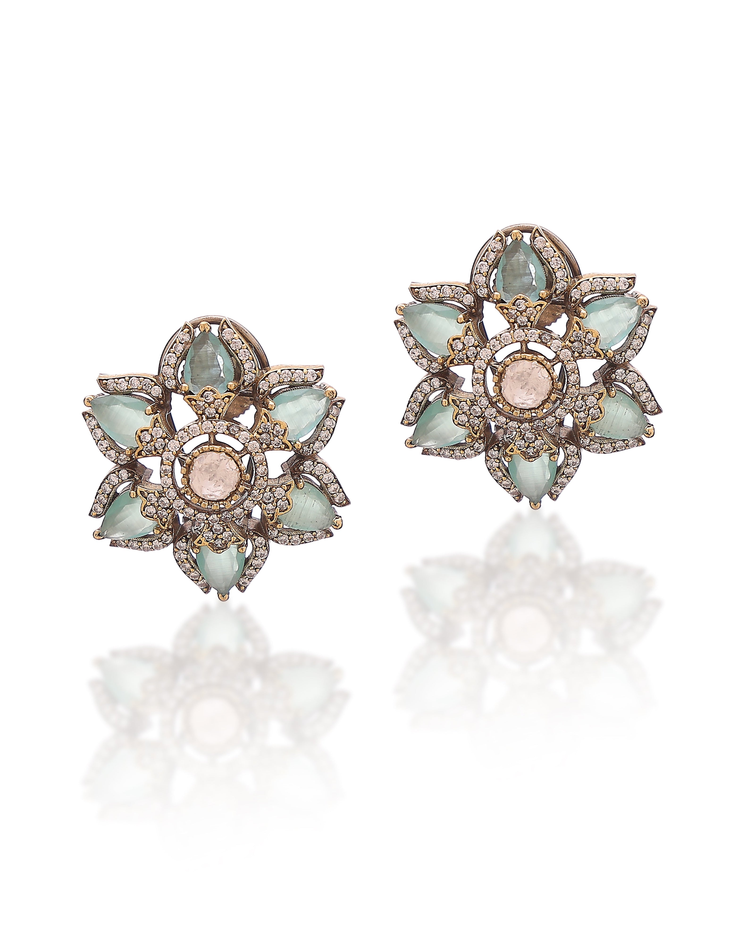 Pair of decorative earrings with gemstones on a white background