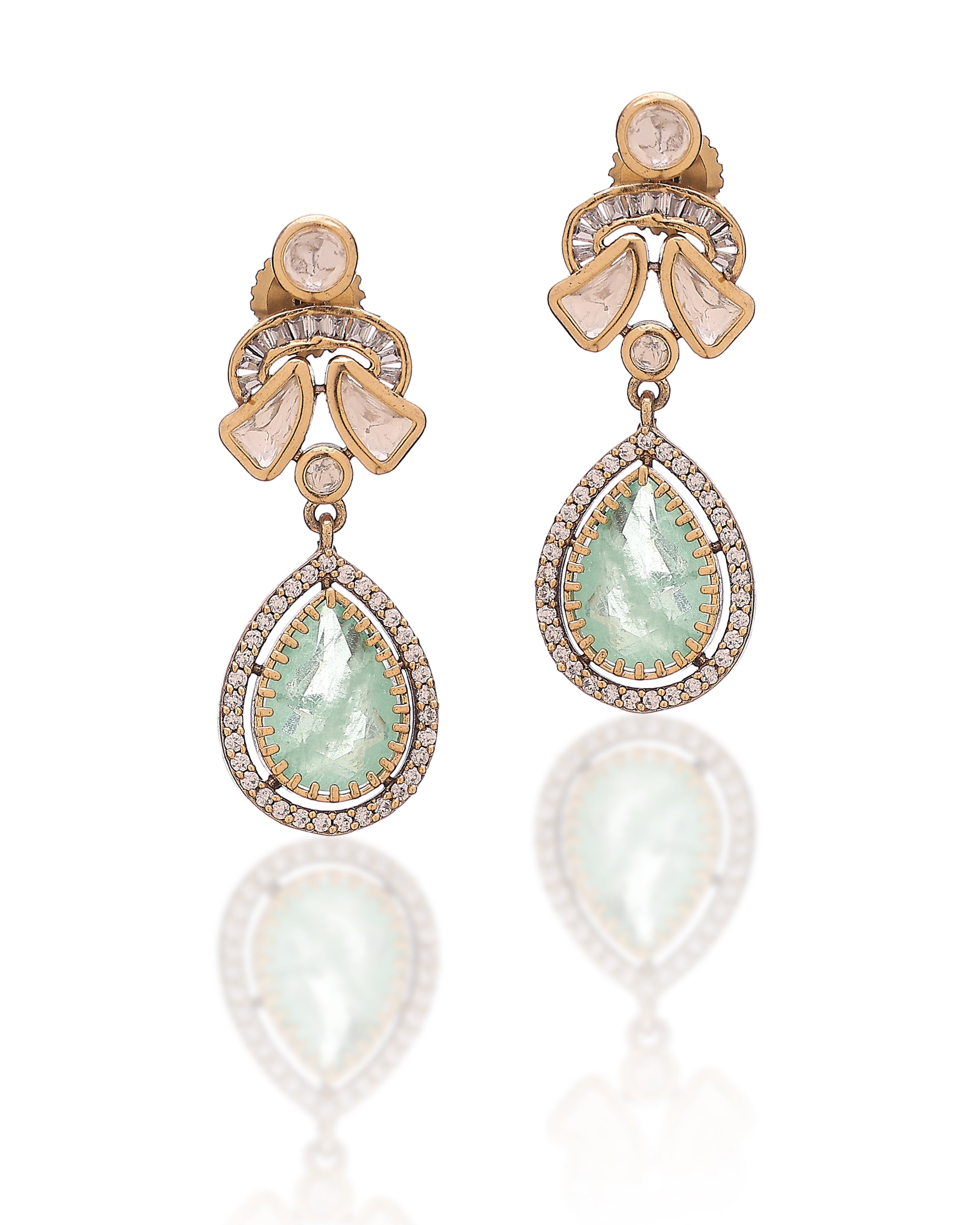 Pair of gold earrings with teardrop-shaped gemstones on a white background