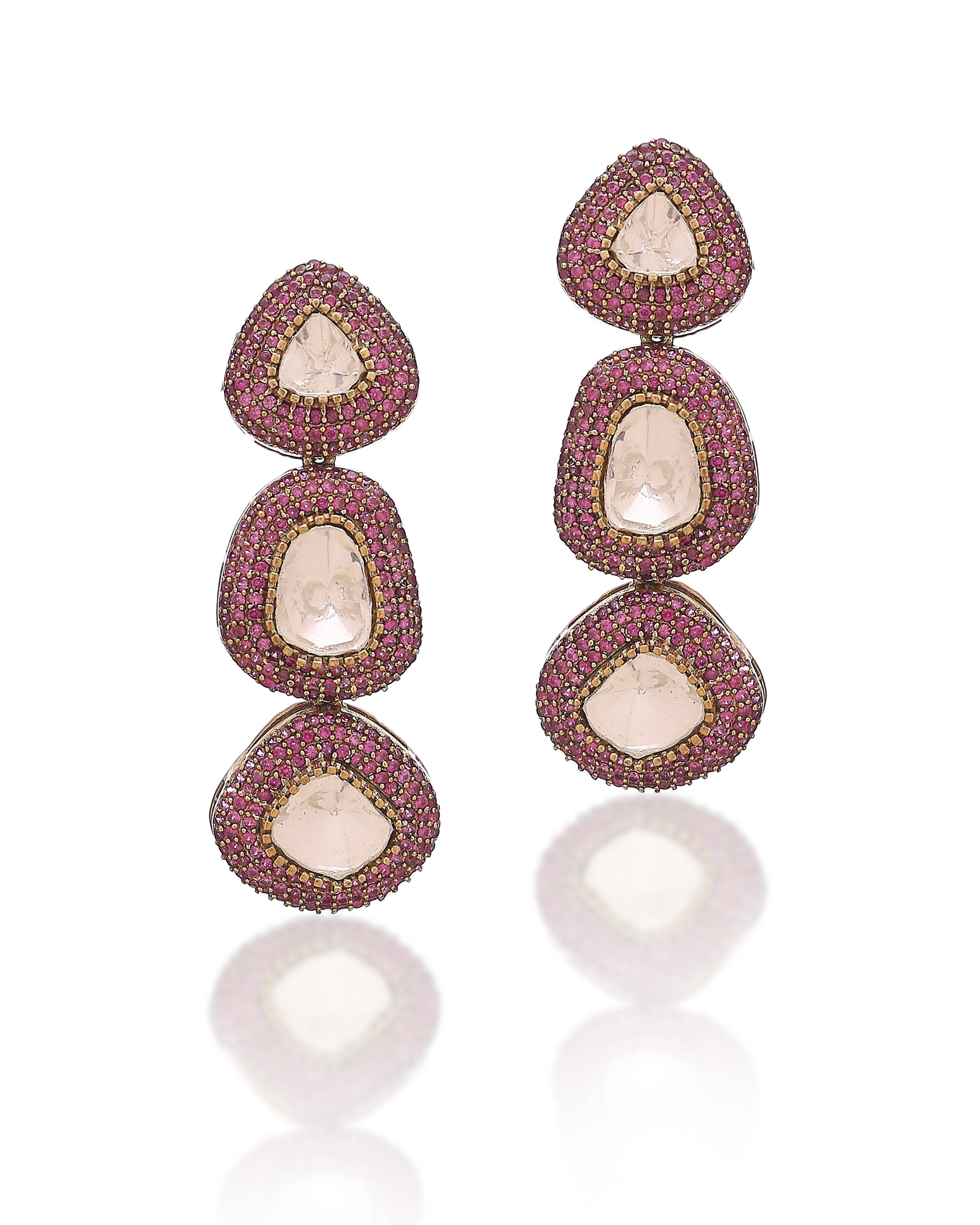 Pair of earrings with pink gemstones on a white background