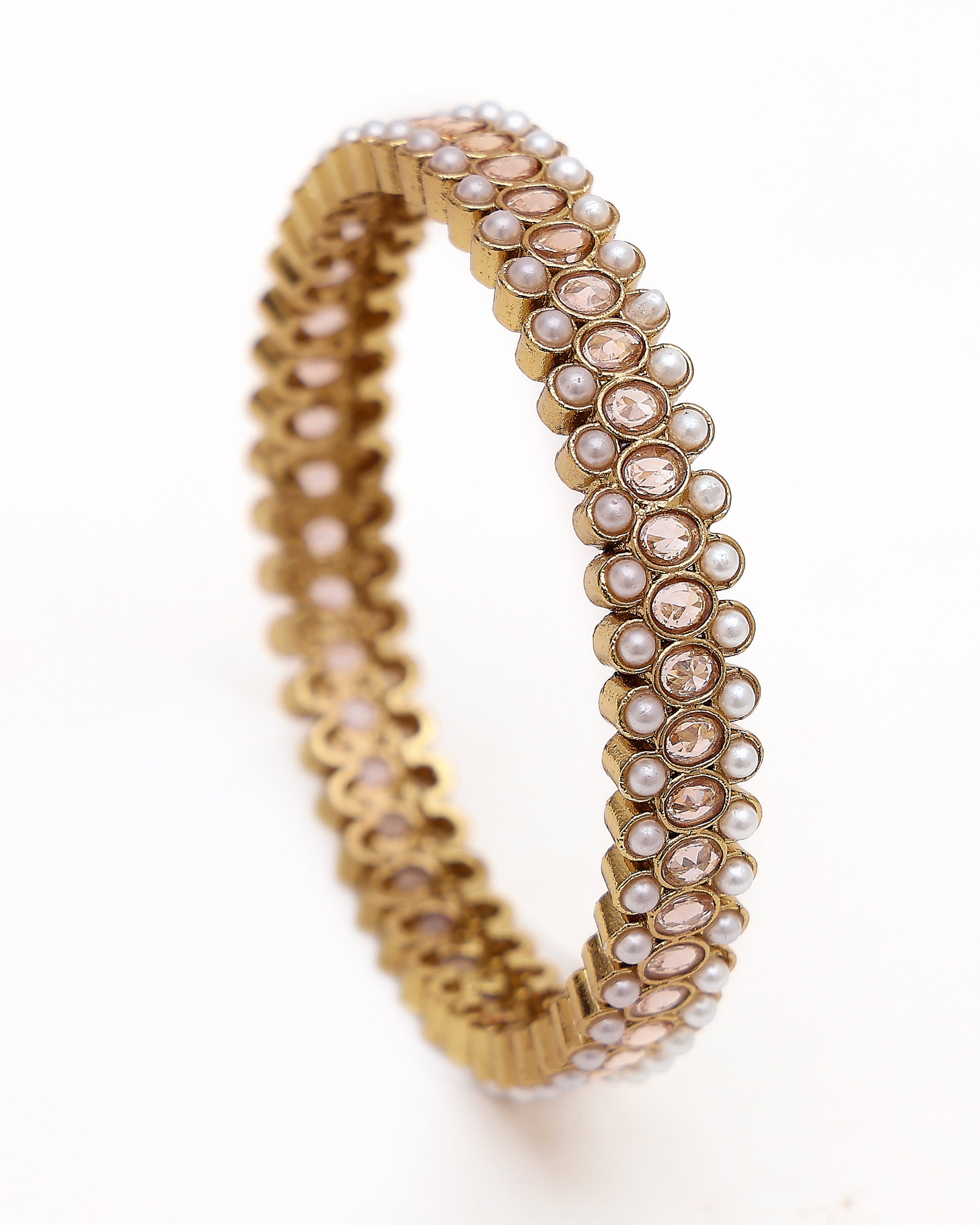Gold bracelet with pearls on a white background