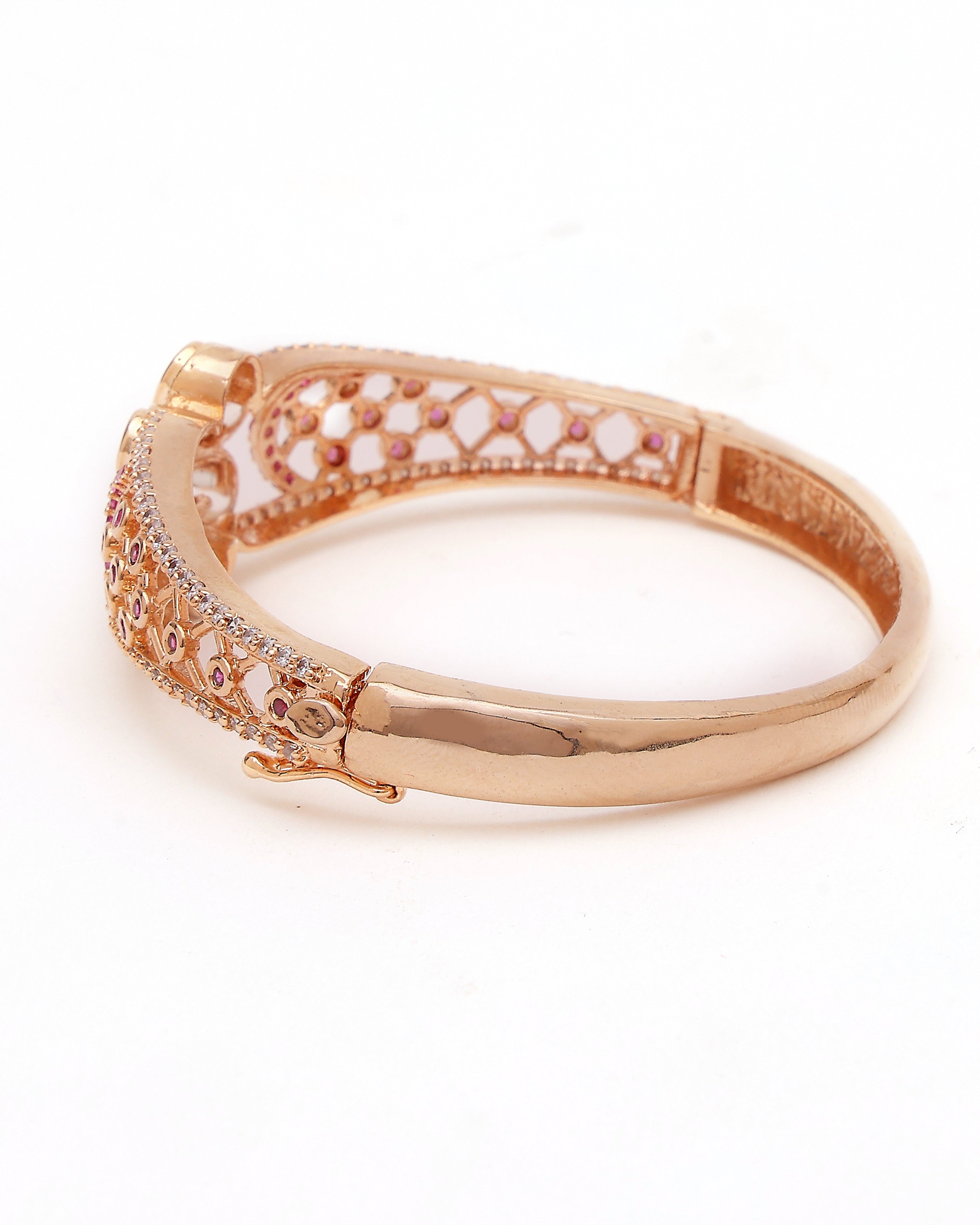 Rose gold bracelet with intricate design on a white background