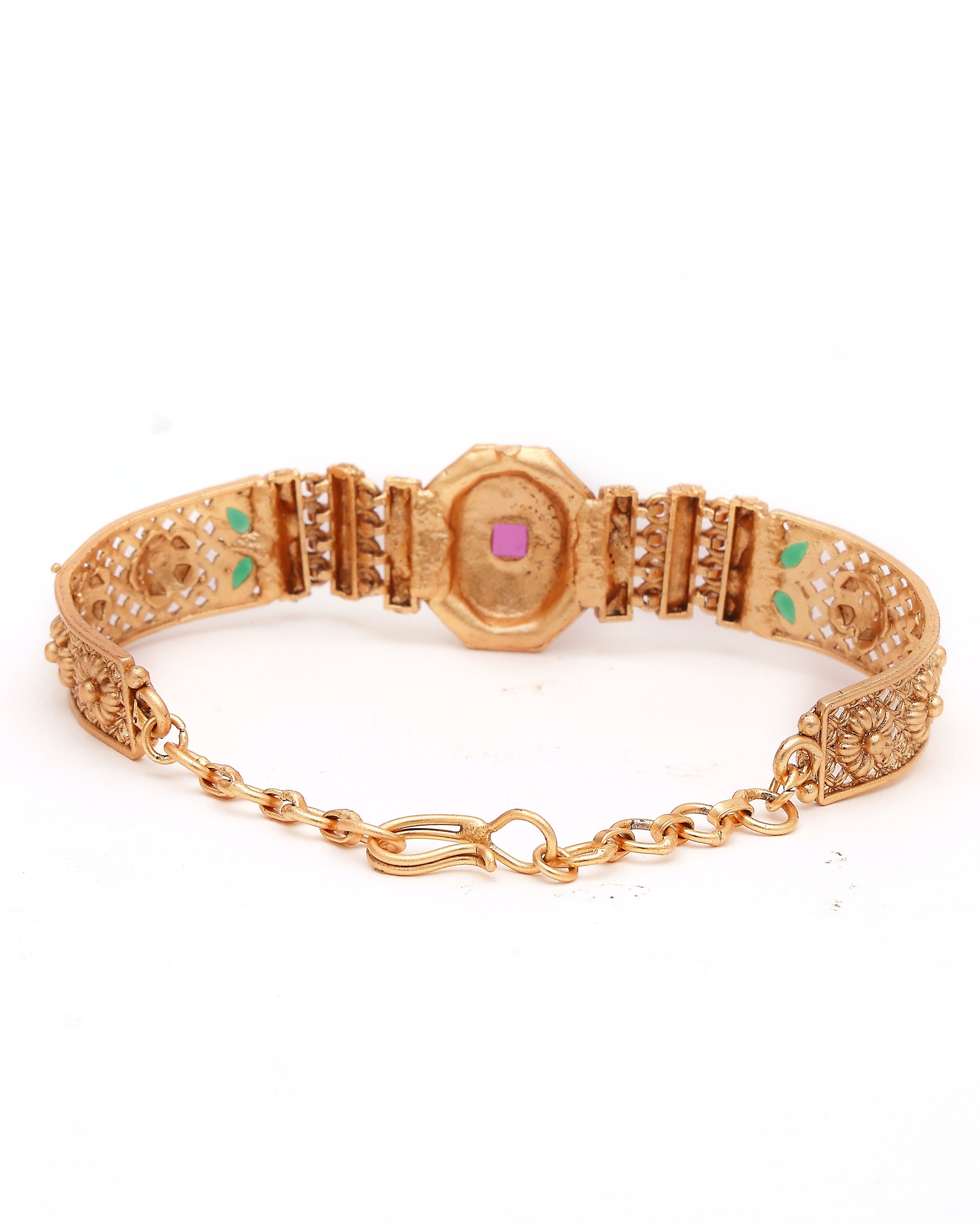 Gold bracelet with gemstones on a white background