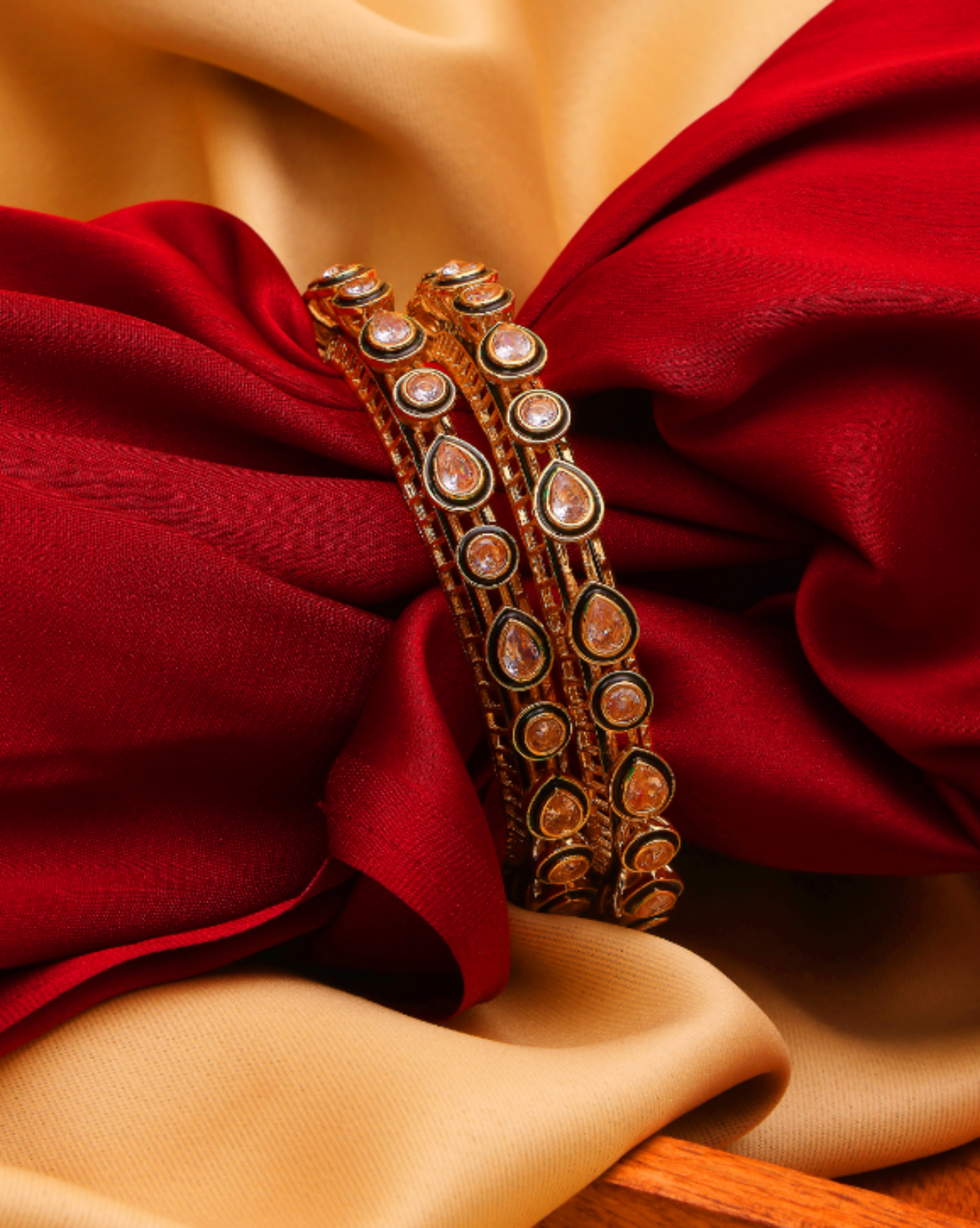 Decorative bangles on a red fabric background