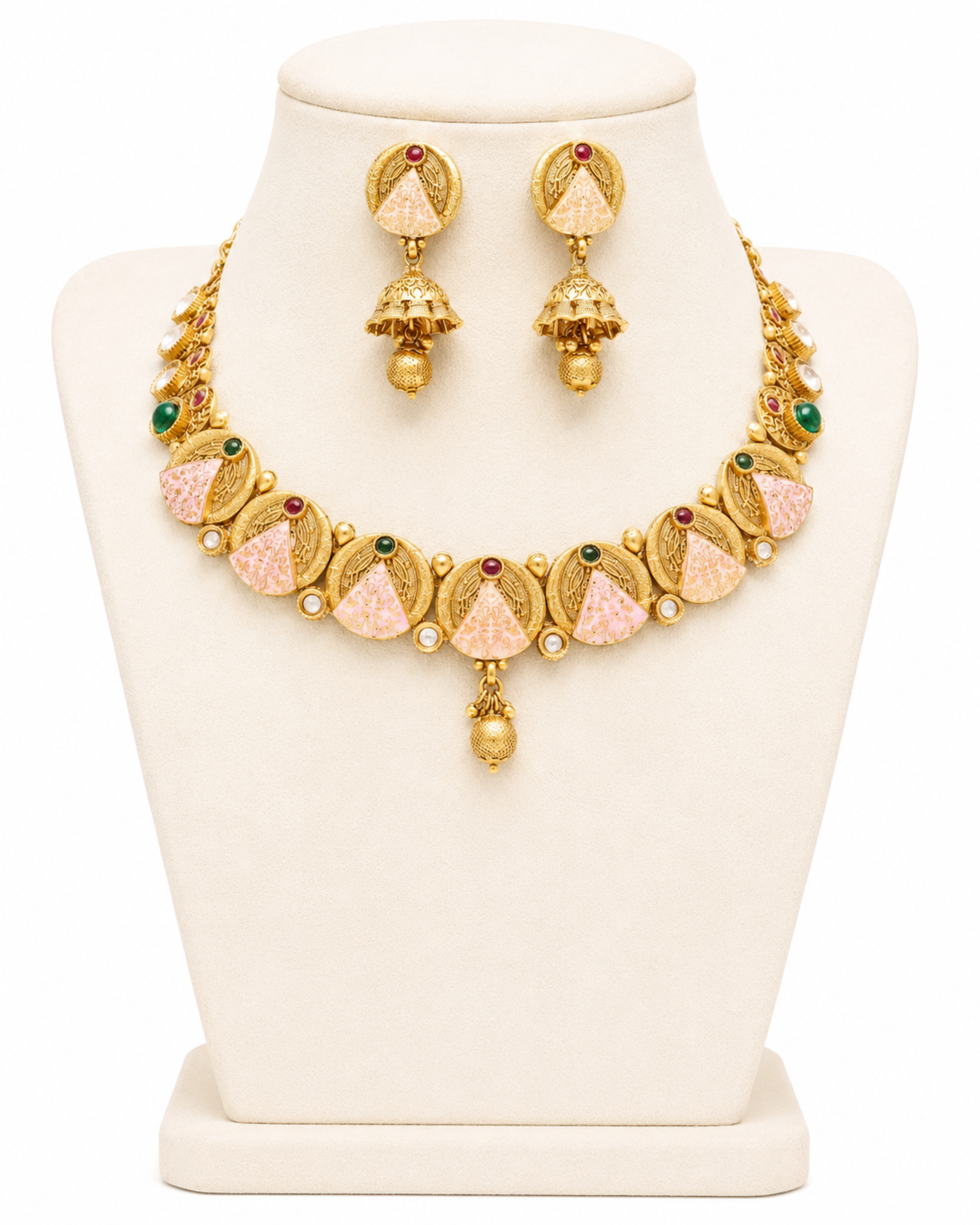 Gold necklace and earrings set on a mannequin bust with a white background