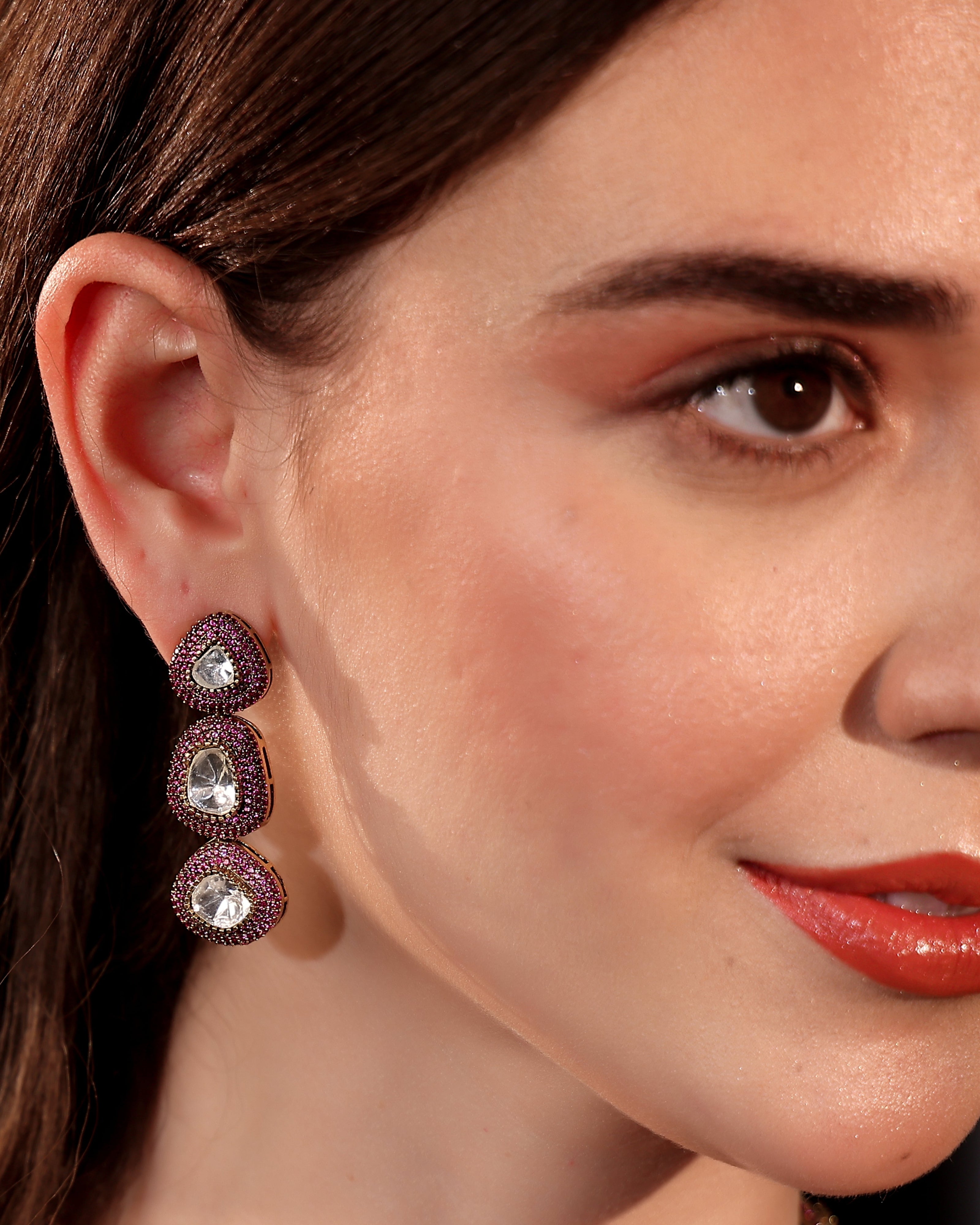 Close-up of a woman wearing a pair of earrings with a blurred background