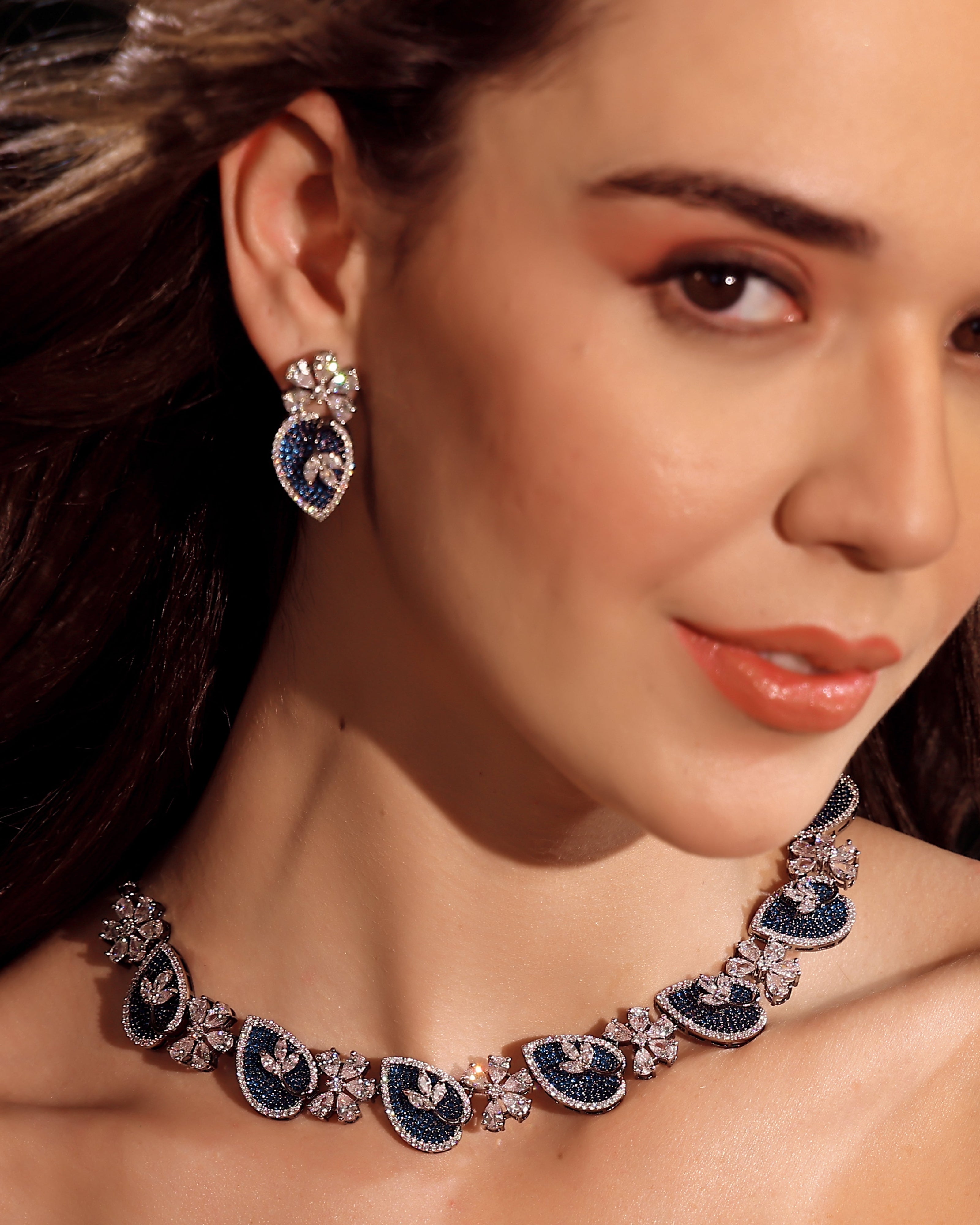 Close-up of a woman wearing a decorative necklace and earrings.