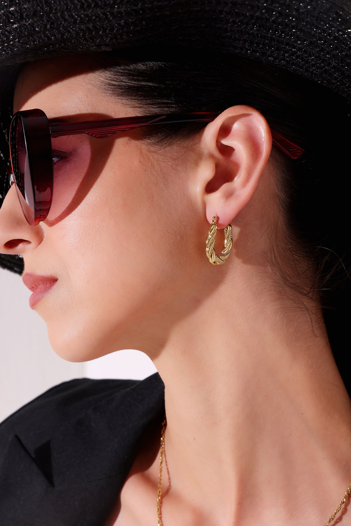 Model wearing Braided Glow Hoops – side profile