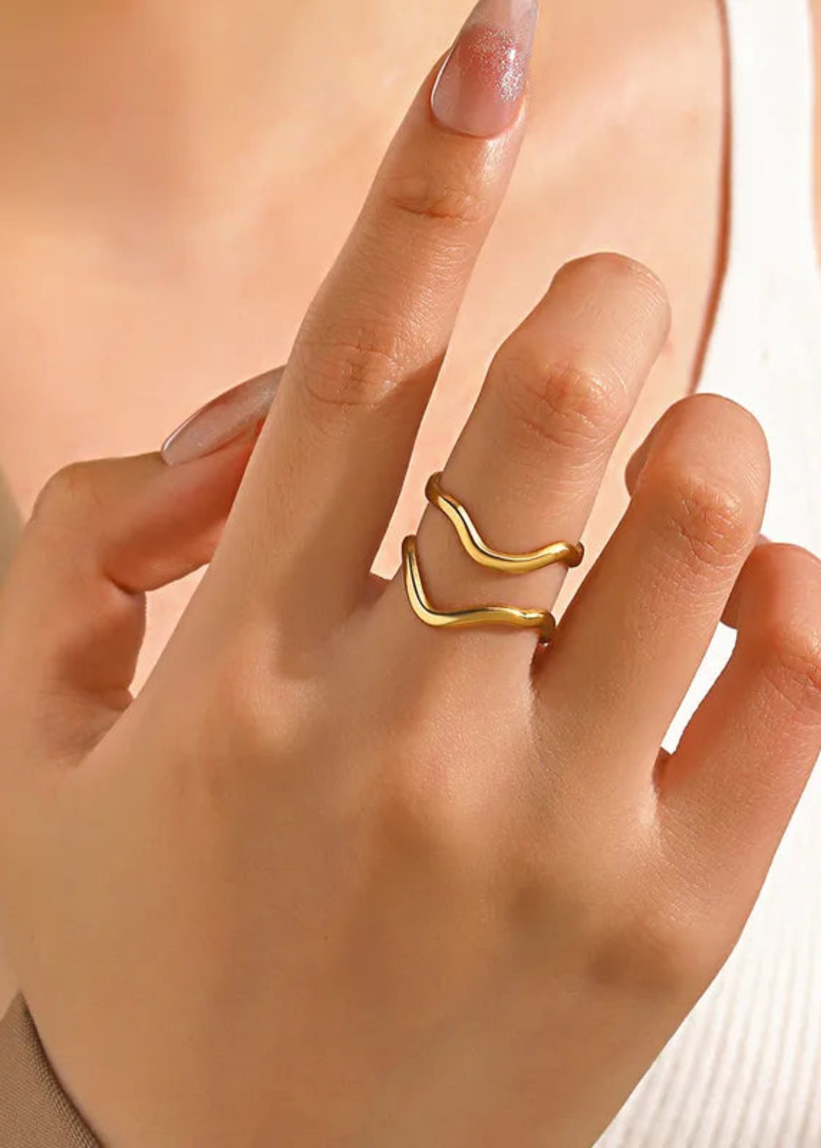 Gold ring on a finger with a soft background