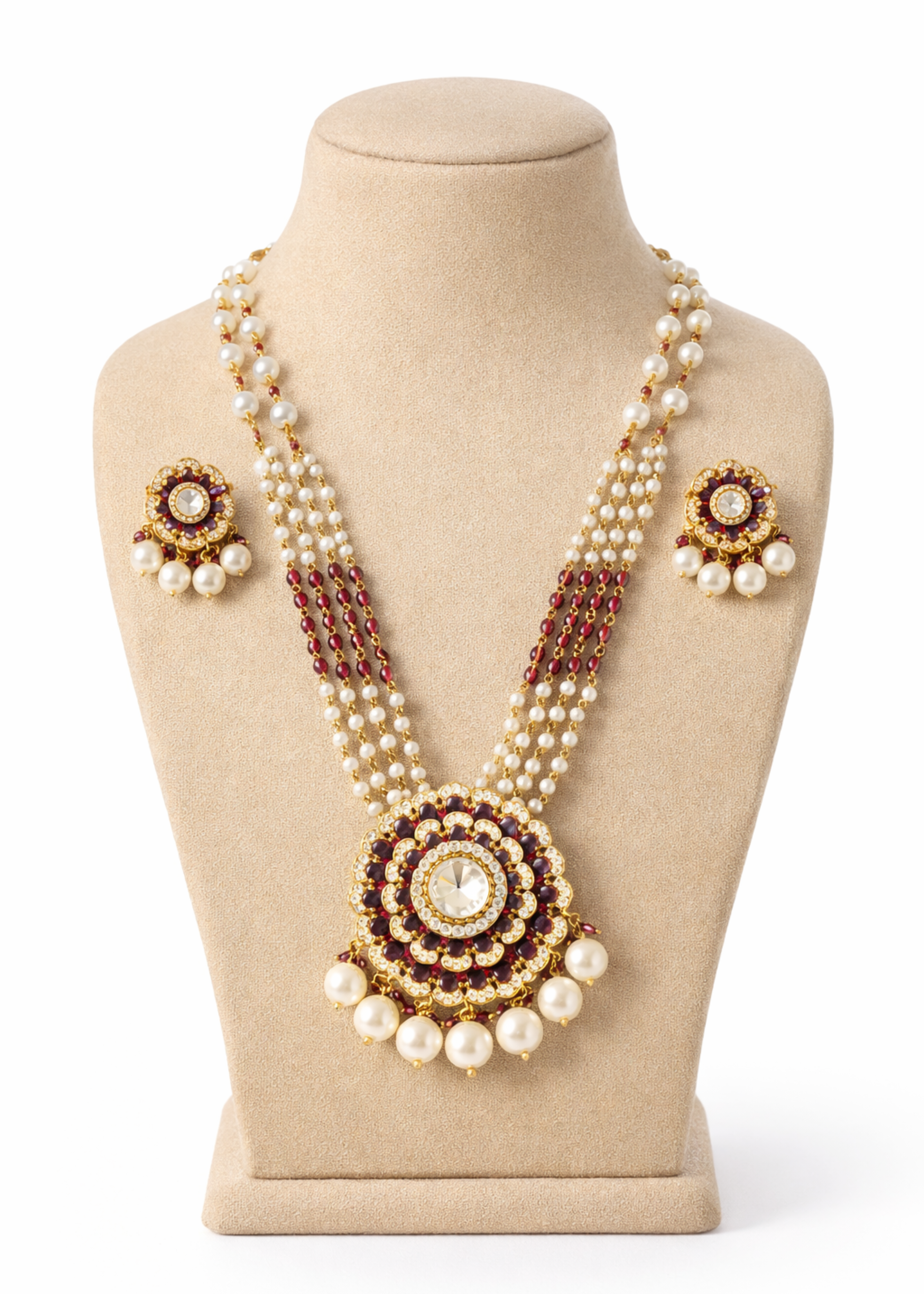 Pearl necklace with gold and red accents on a mannequin bust against a white background