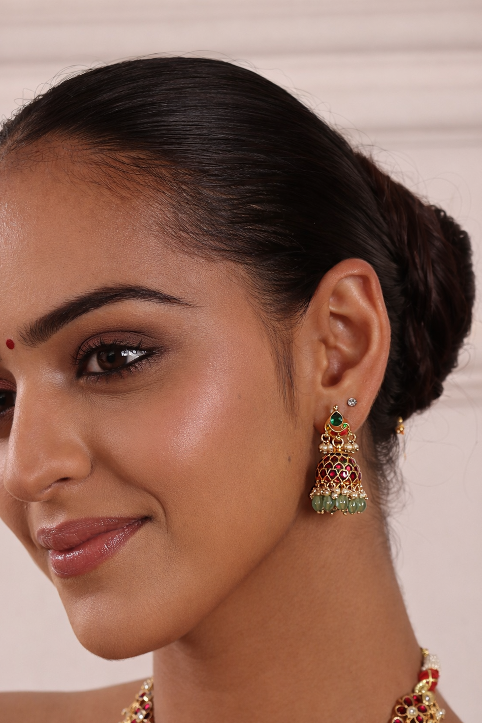 Woman wearing traditional jewelry with a neutral background