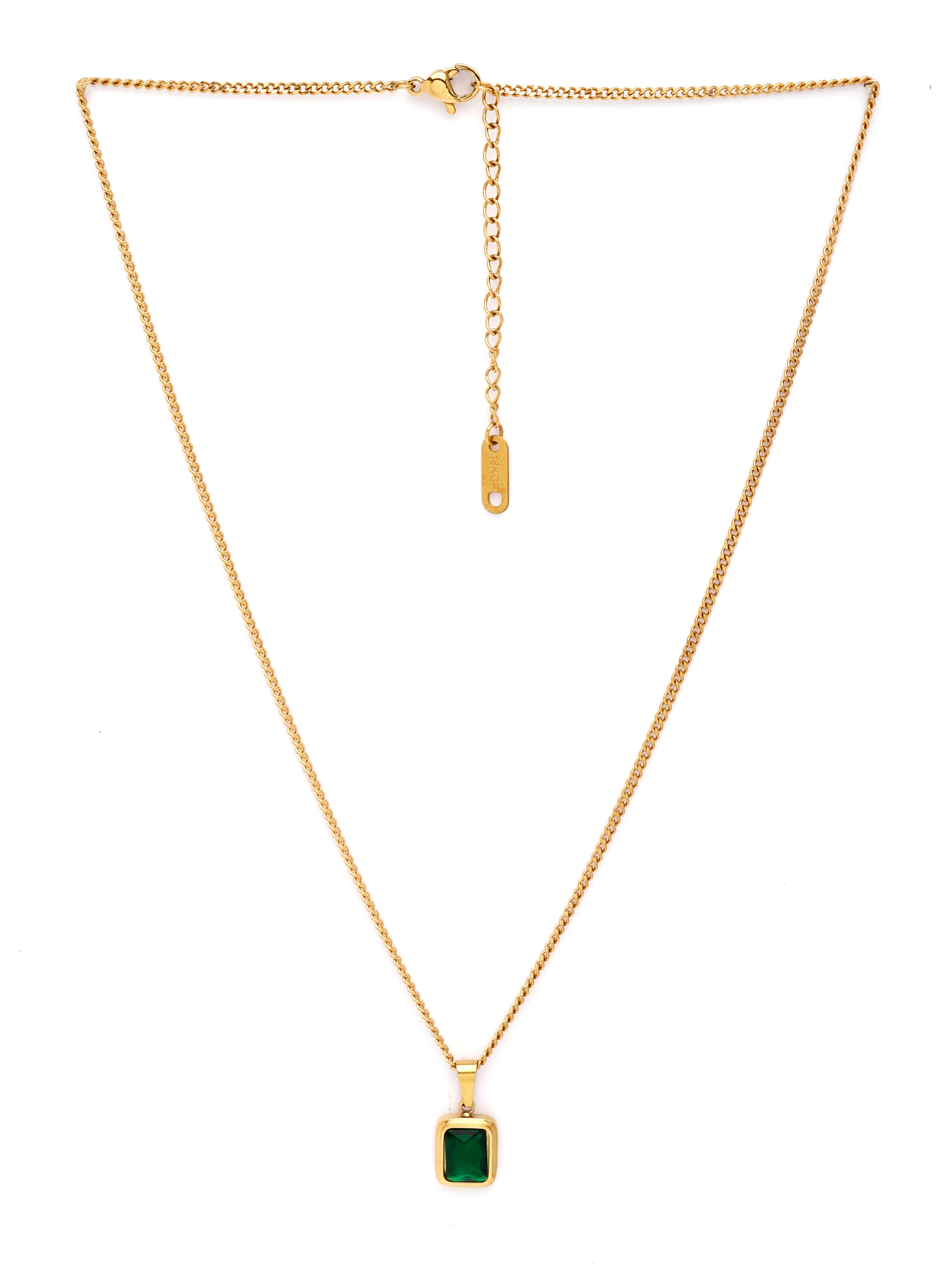 Gold necklace with a green pendant on a white background