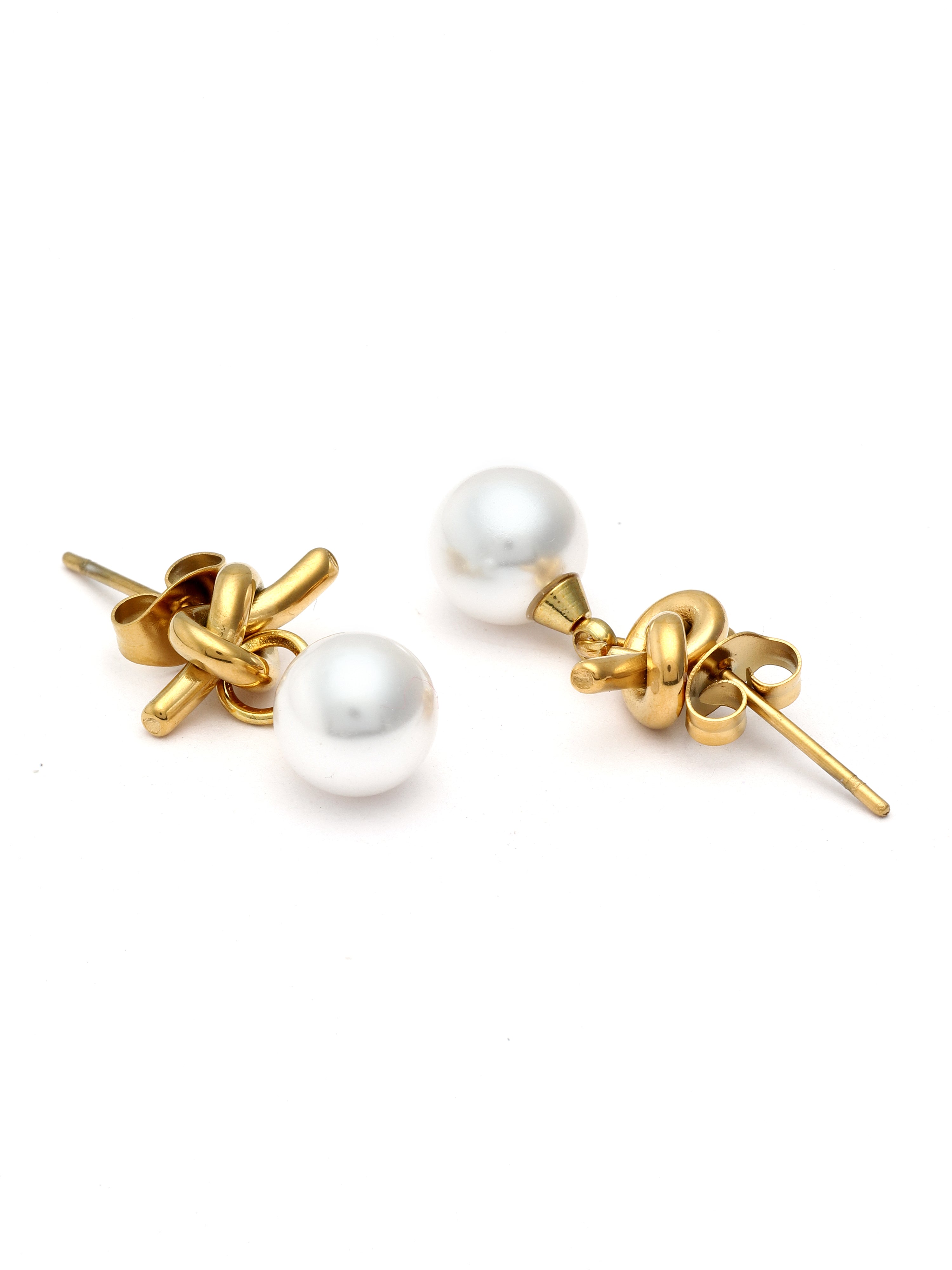 Pair of pearl earrings with gold knotted designs on a white background