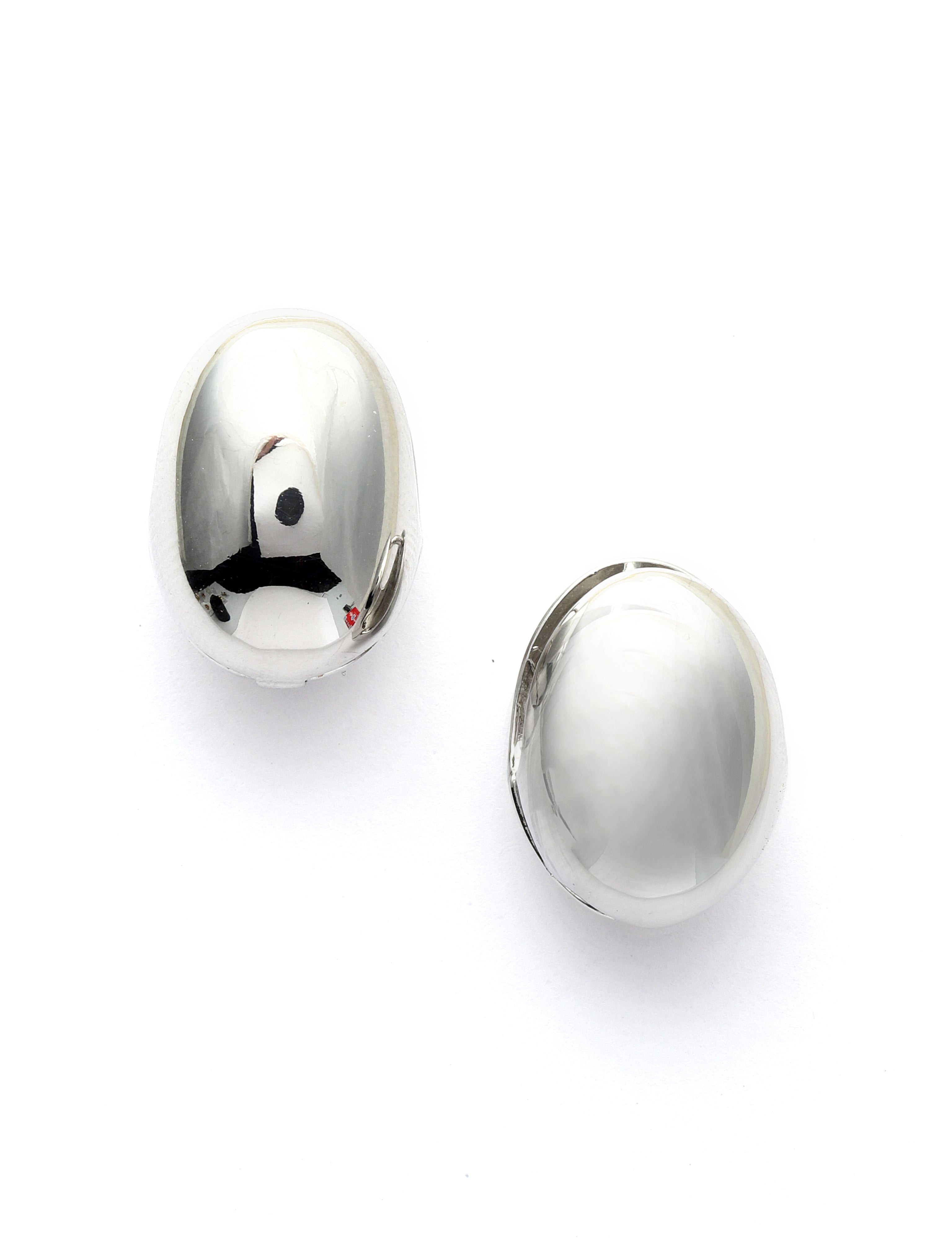 Pair of silver oval earrings on a white background