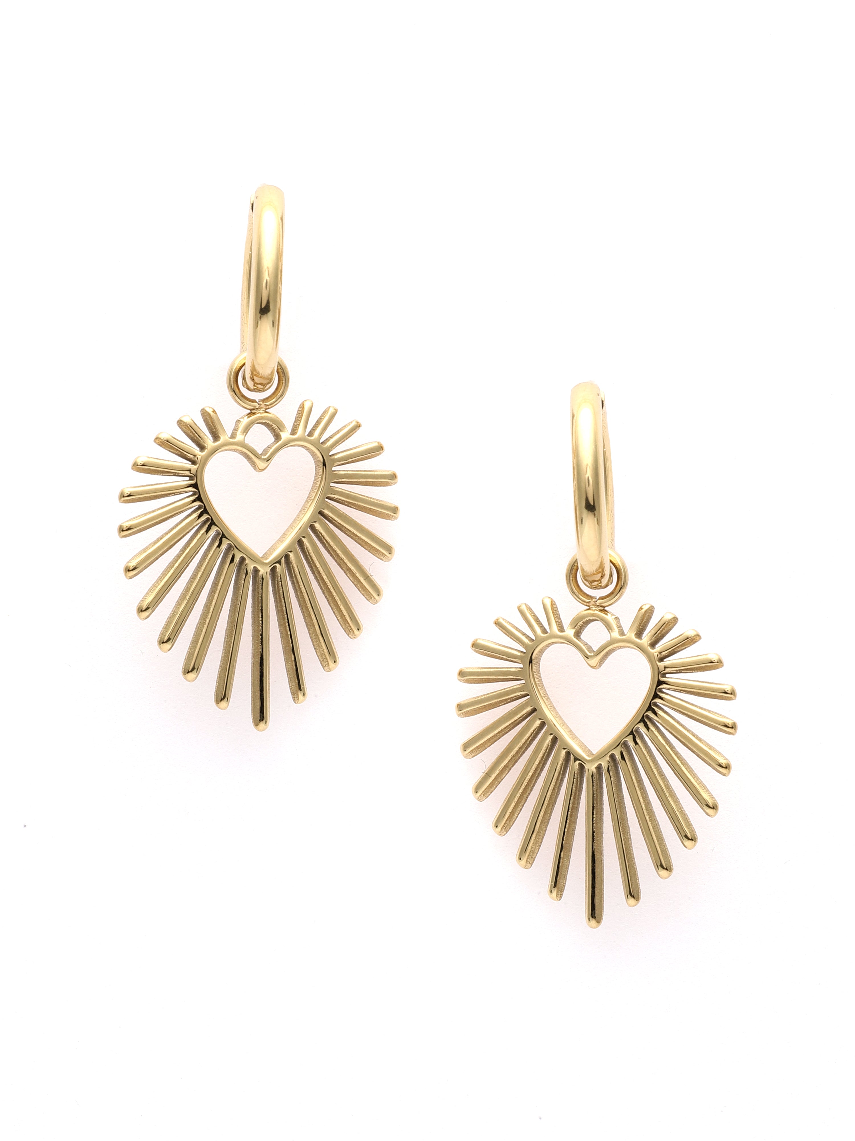 Gold heart-shaped earrings with sunburst design on a white background