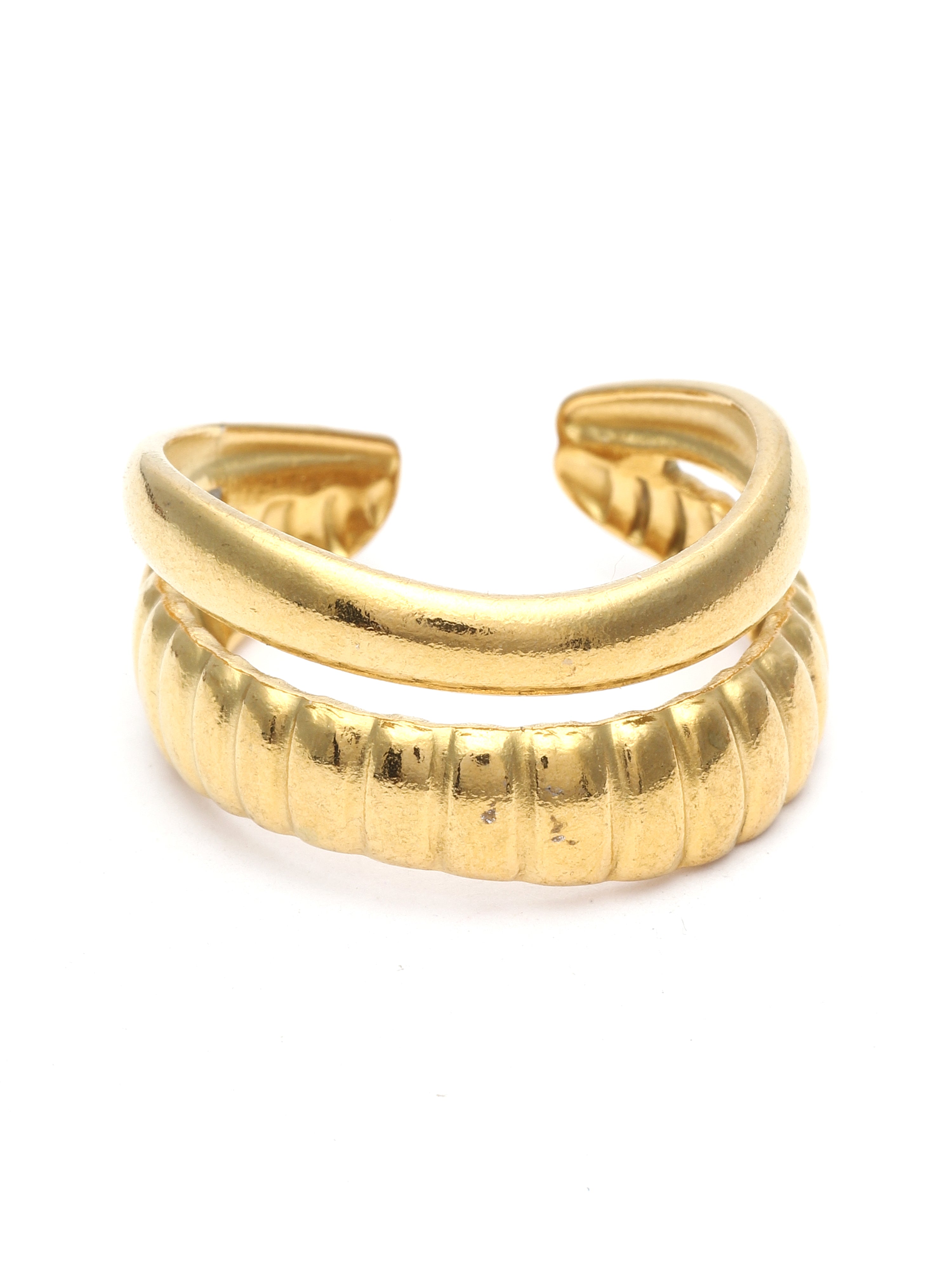 Gold open-toe shoe on a white background