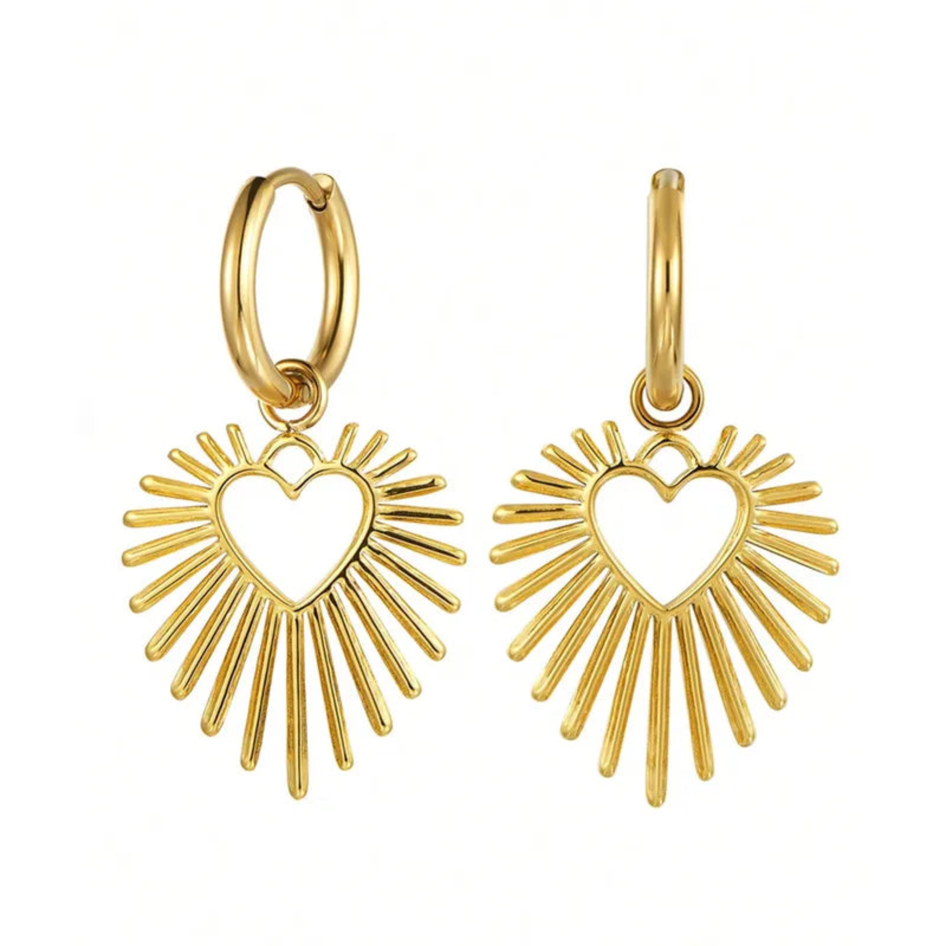 Gold heart-shaped earrings with sunburst design on a white background