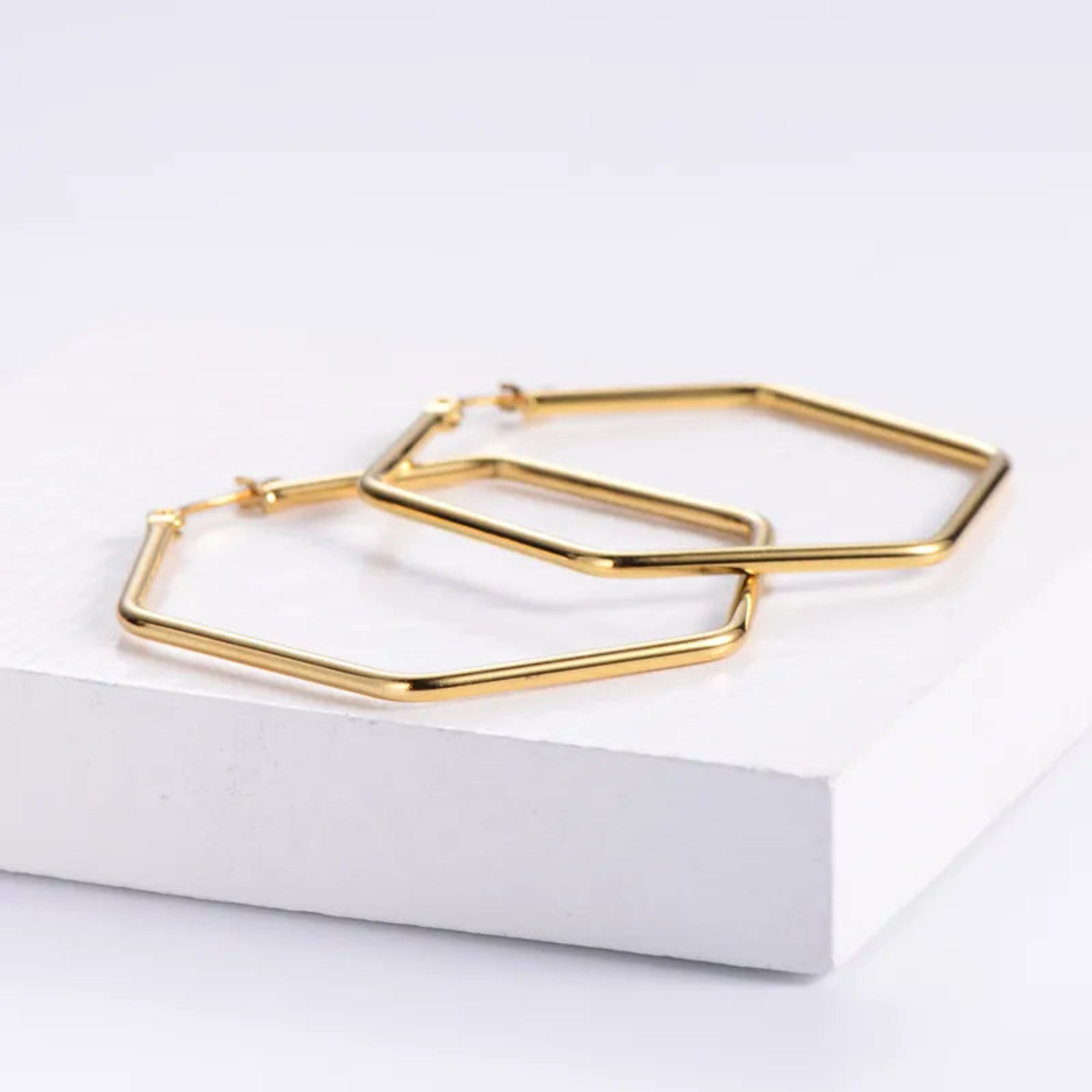 Gold hoop earrings on a white background