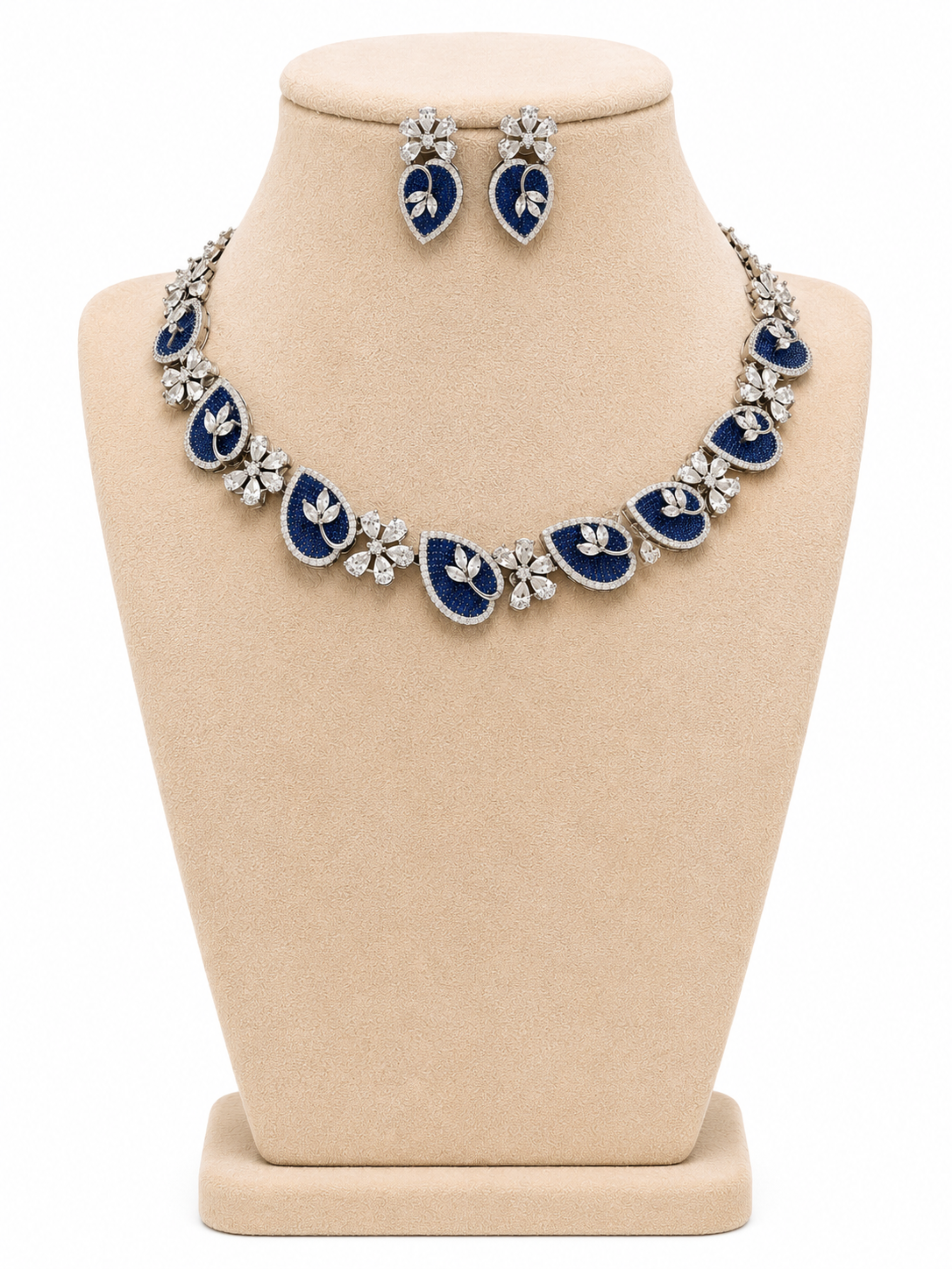 Blue and silver necklace and earrings on a beige display bust