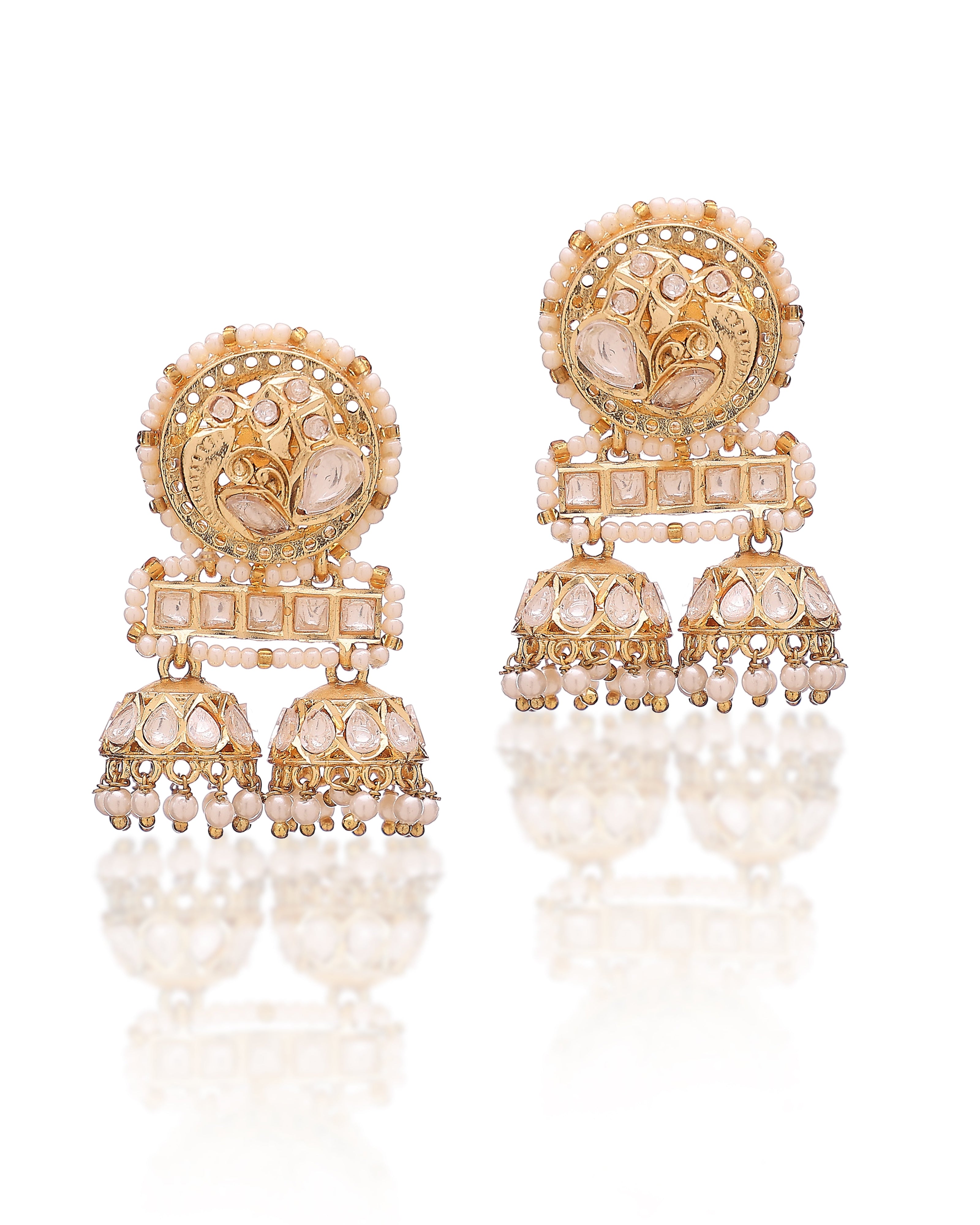 Gold and pearl earrings on a white background