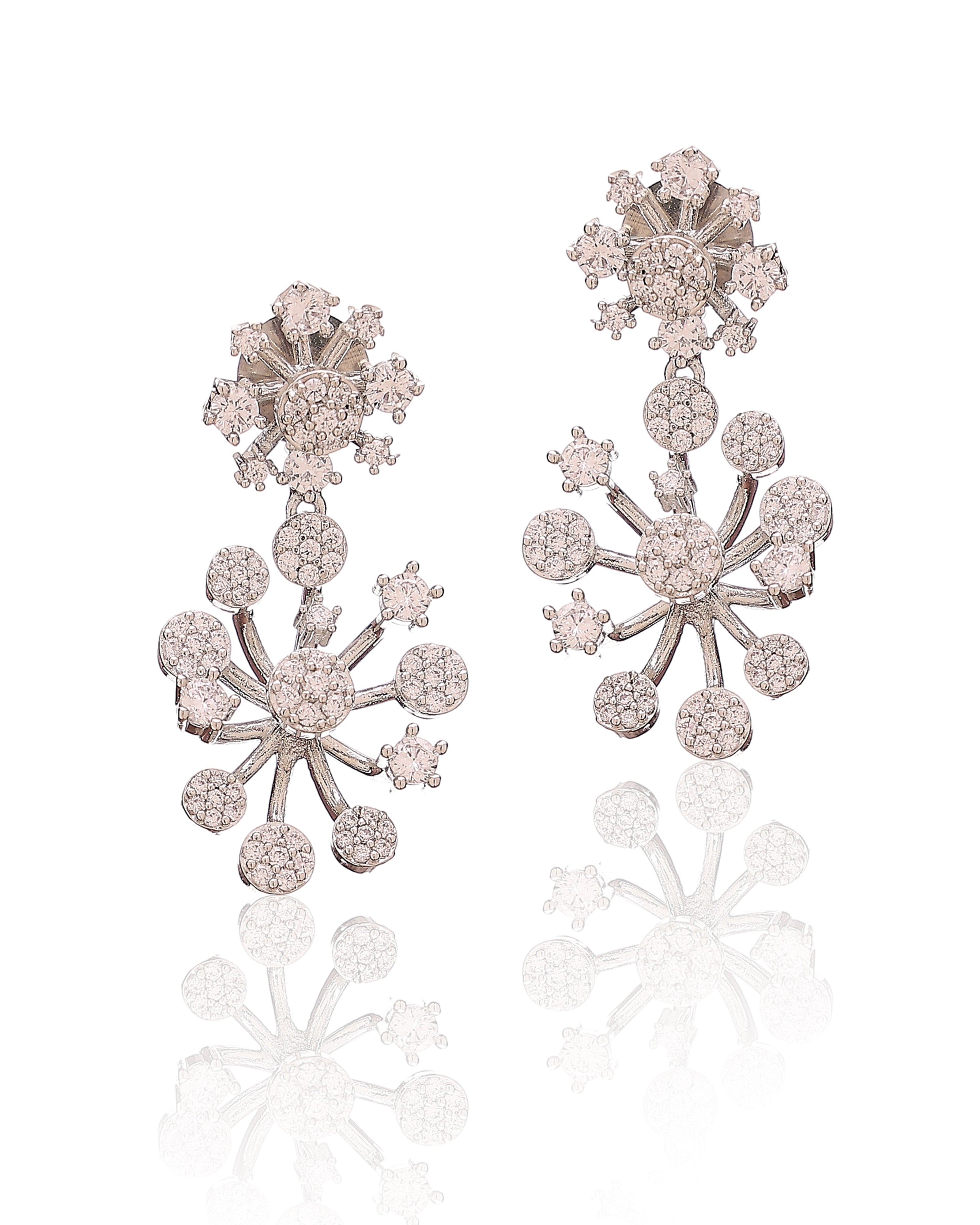 Pair of silver snowflake earrings with clear stones on a white background