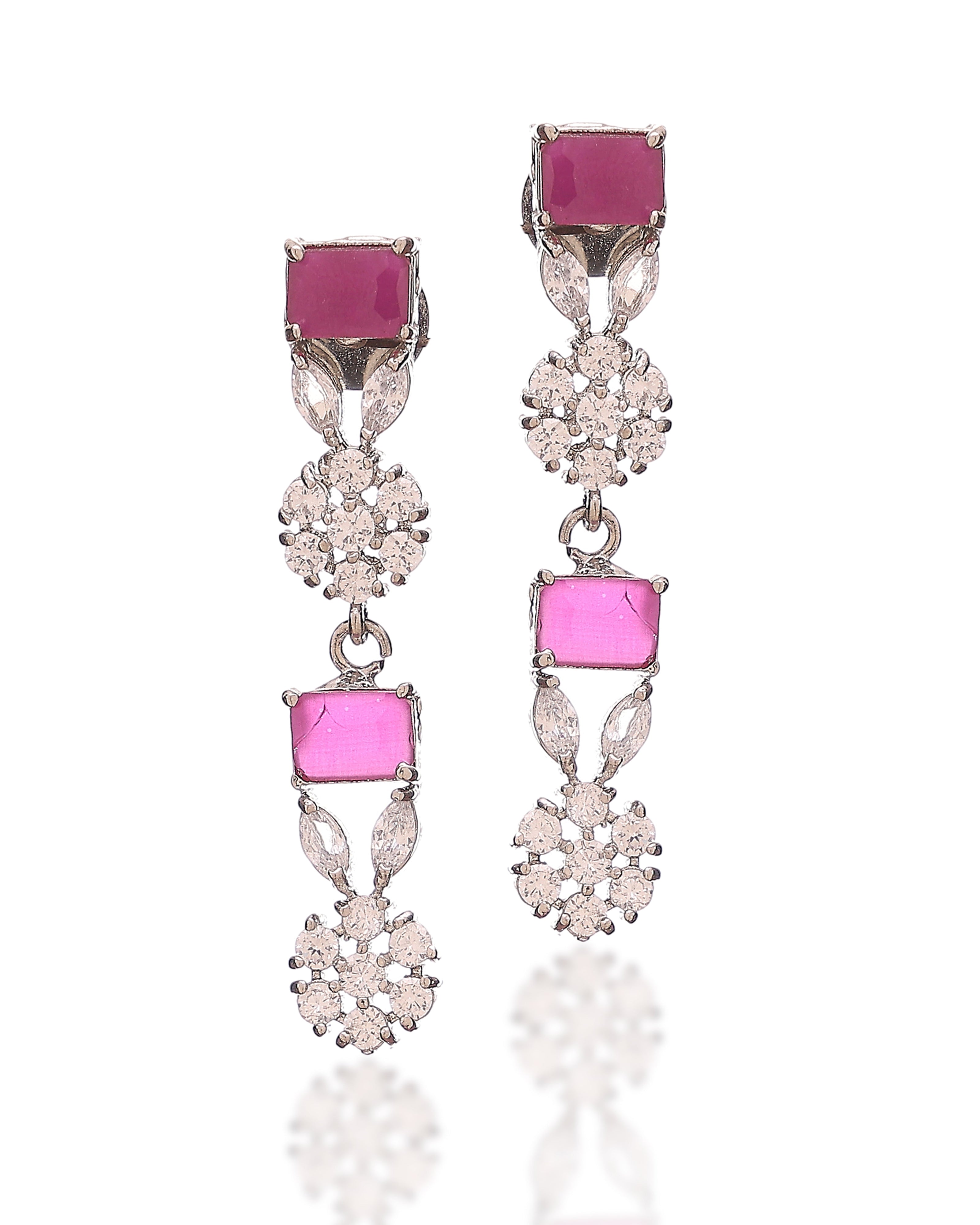 Pair of earrings with pink gemstones and silver or white gold setting on a white background