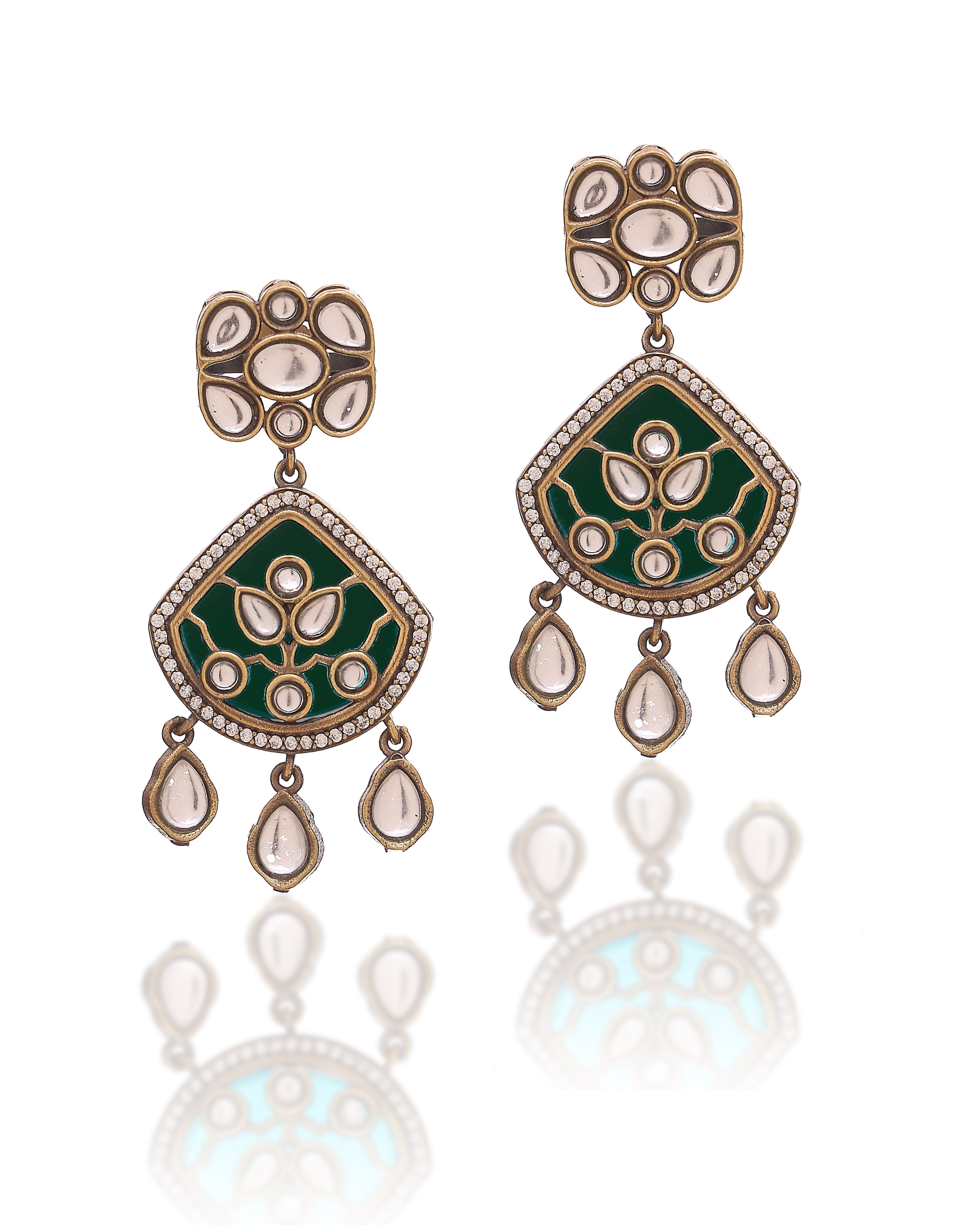 Pair of ornate earrings with green enameled setting and gold detailing on a white background