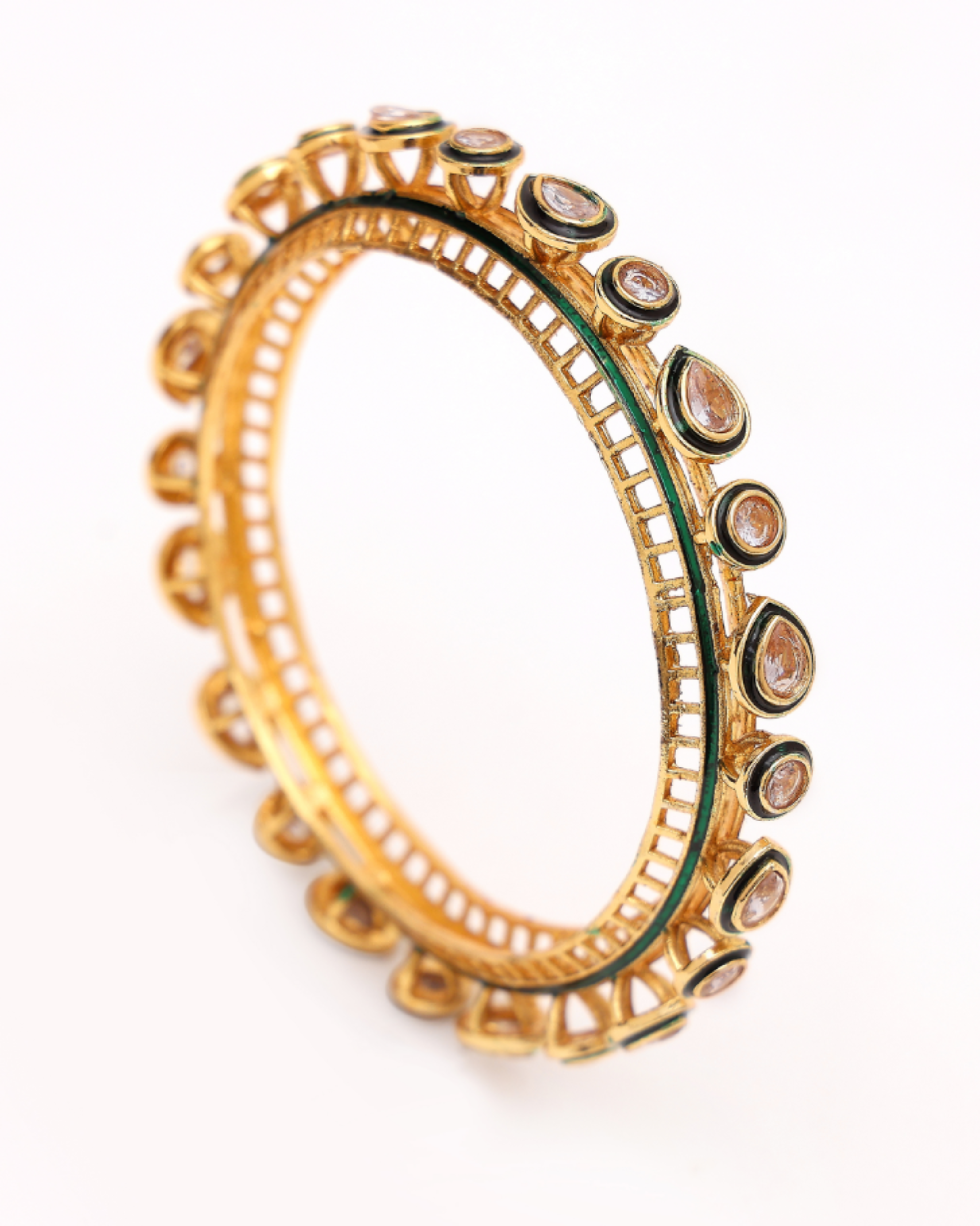 Gold bracelet with gemstones on a white background