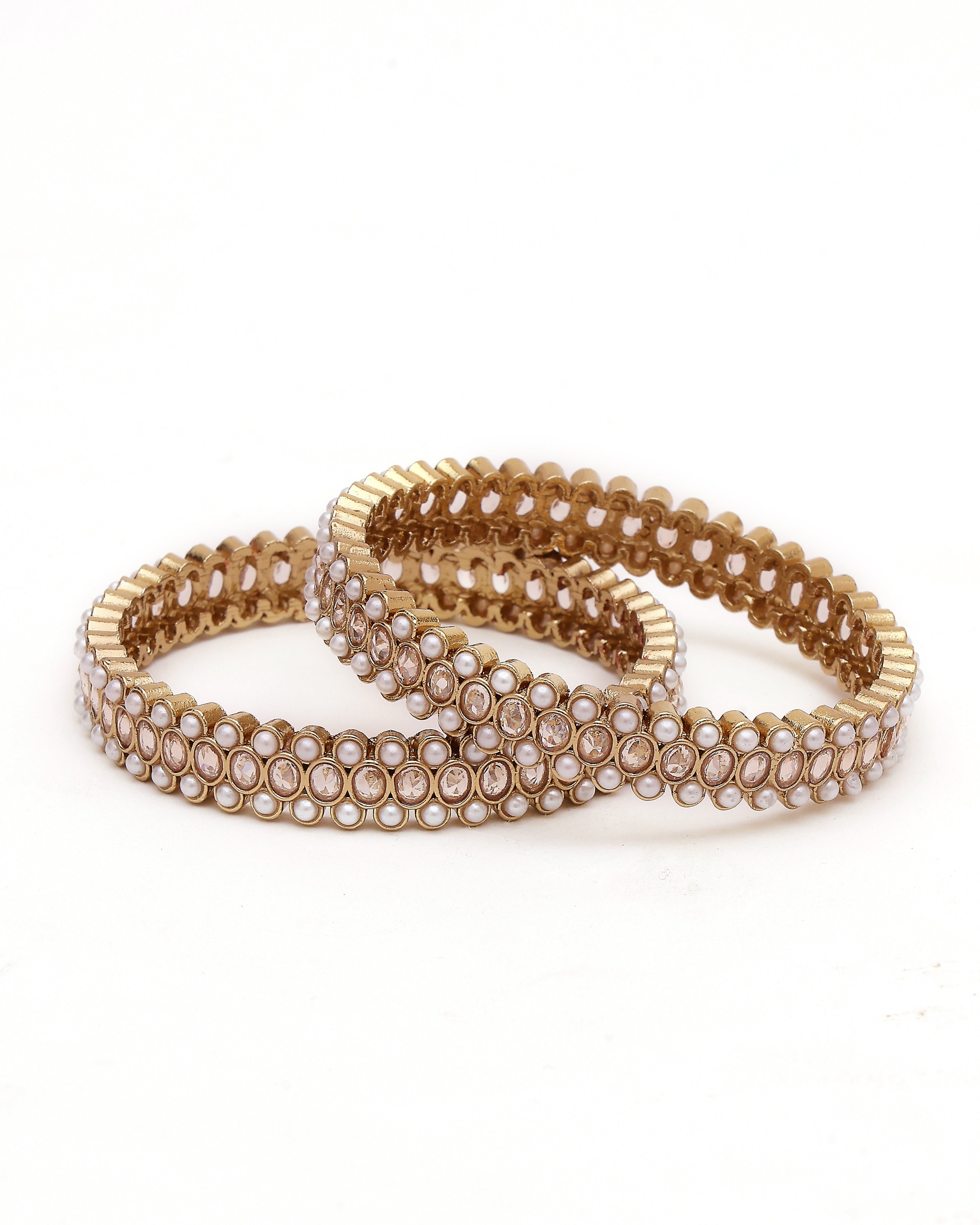 Gold bracelet with pearl-like stones on a white background