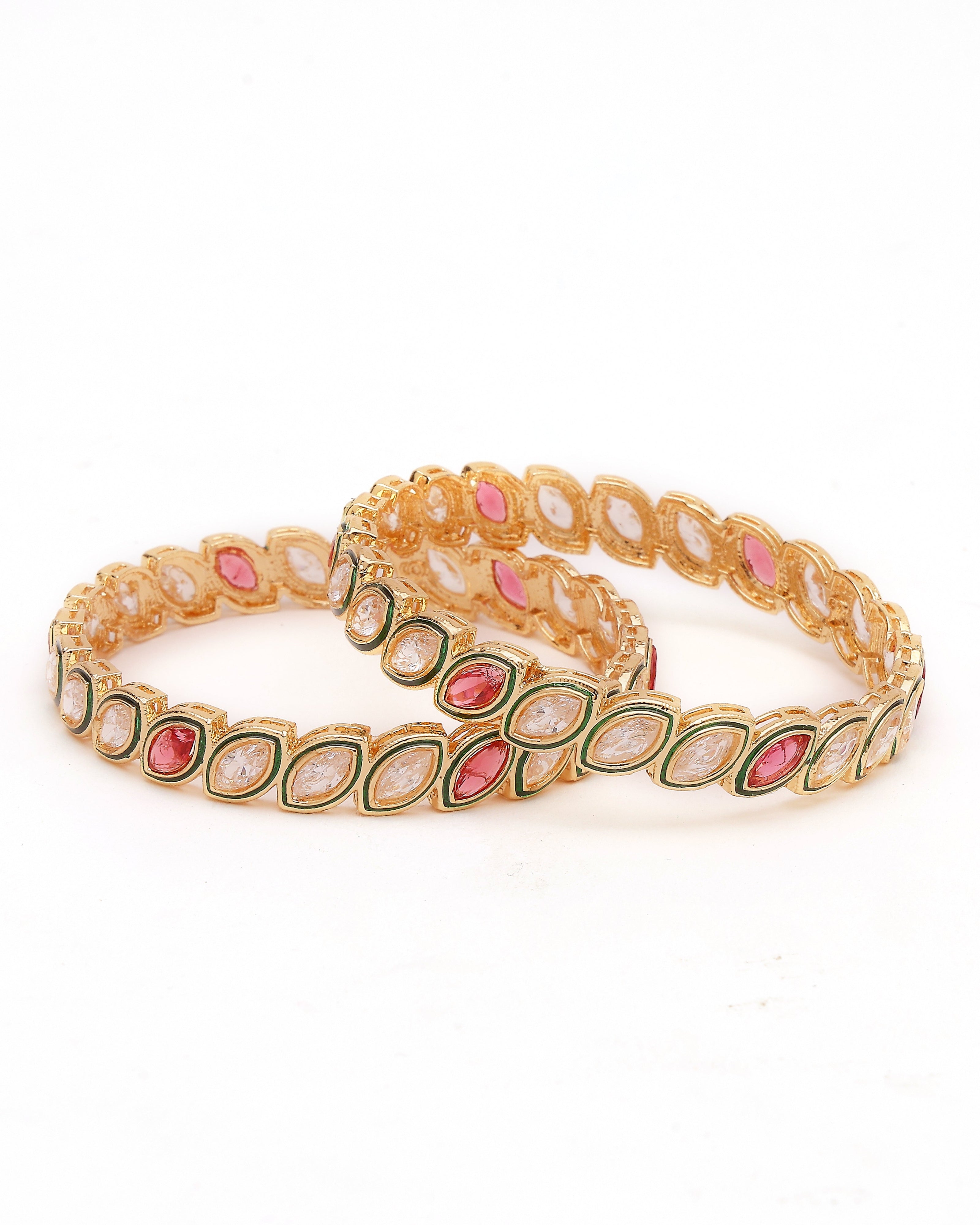 Gold bracelet with pink and green stones on a white background