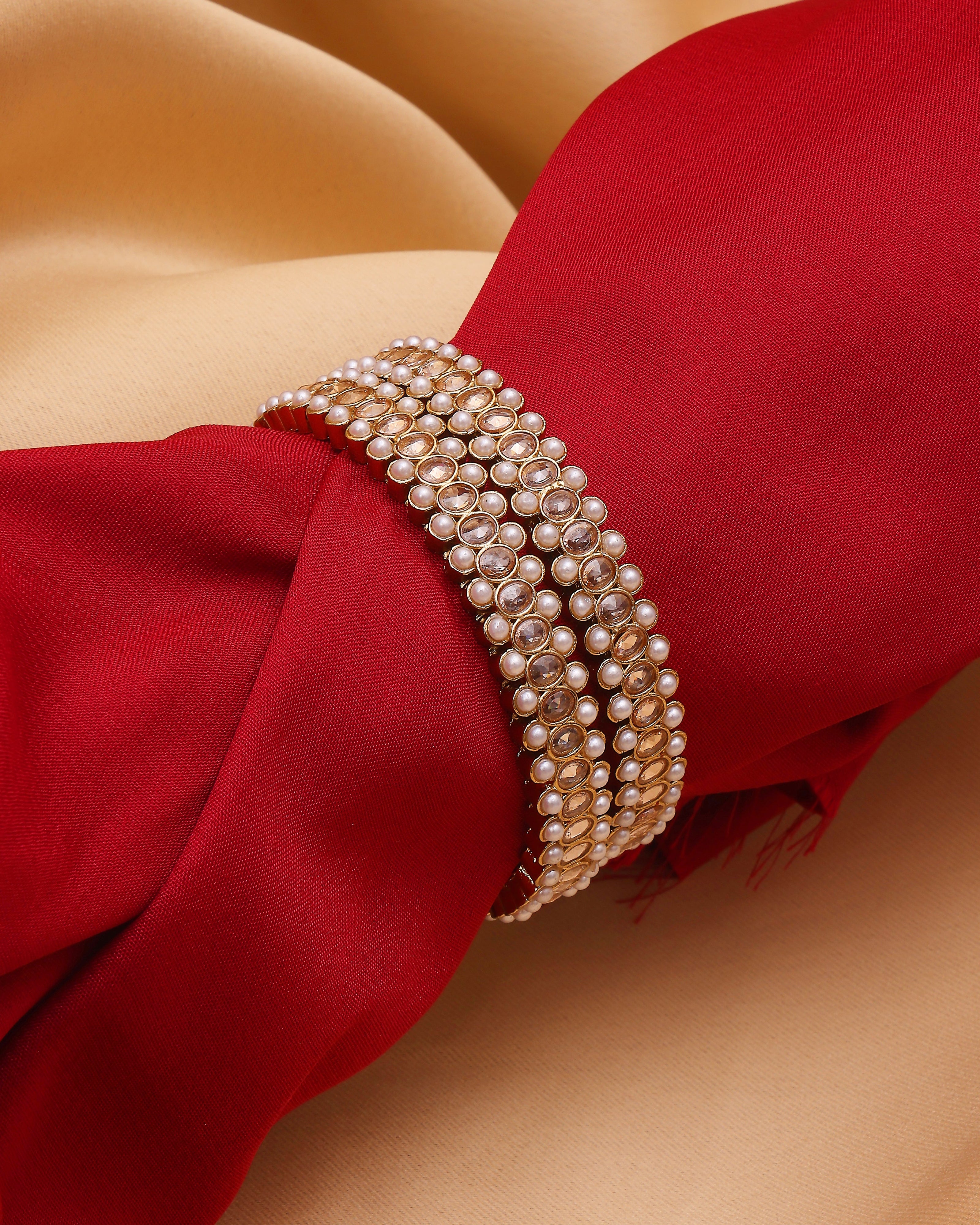 Pearl bracelet on a red fabric background