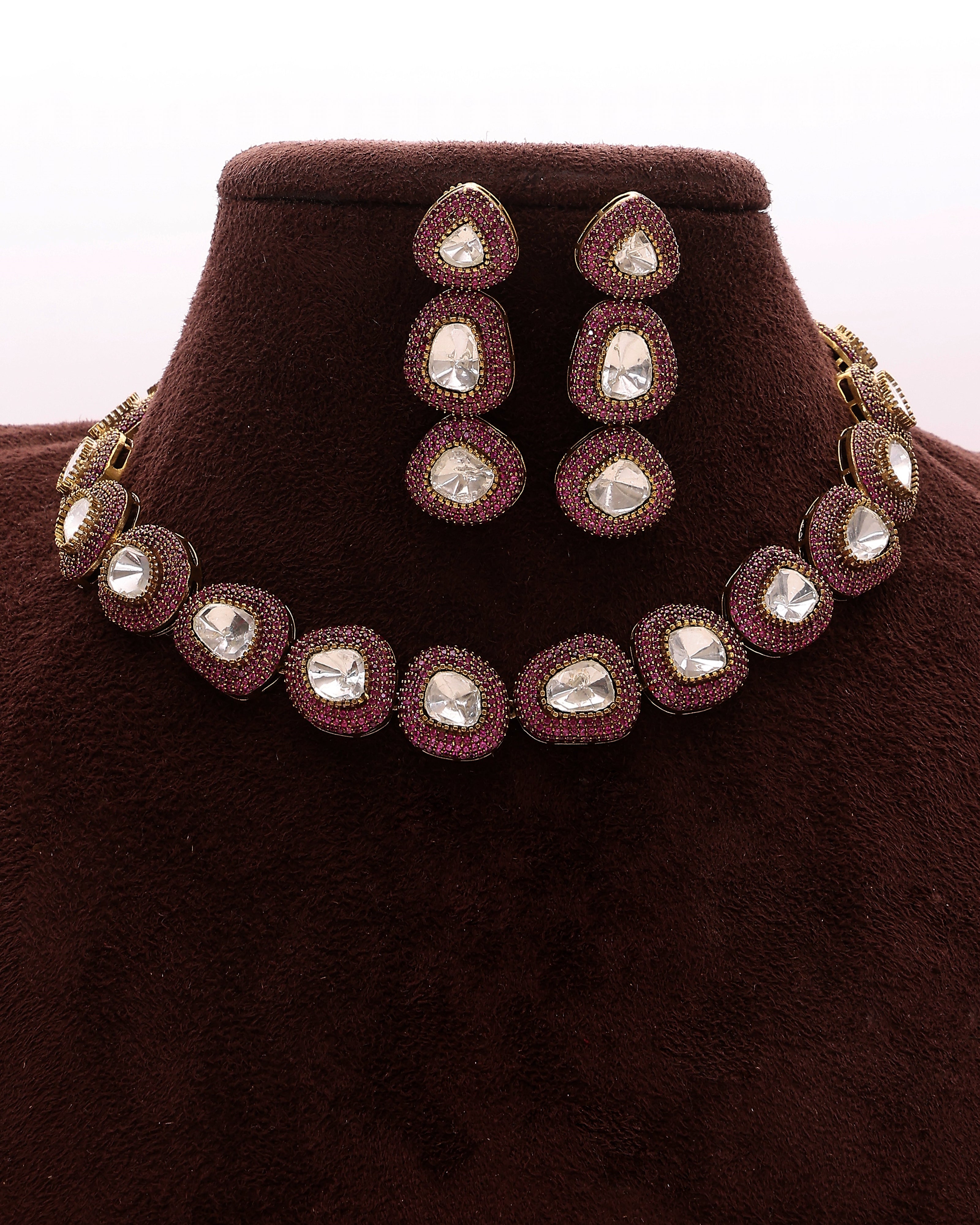 Jewelry set with necklace and earrings on a brown velvet stand