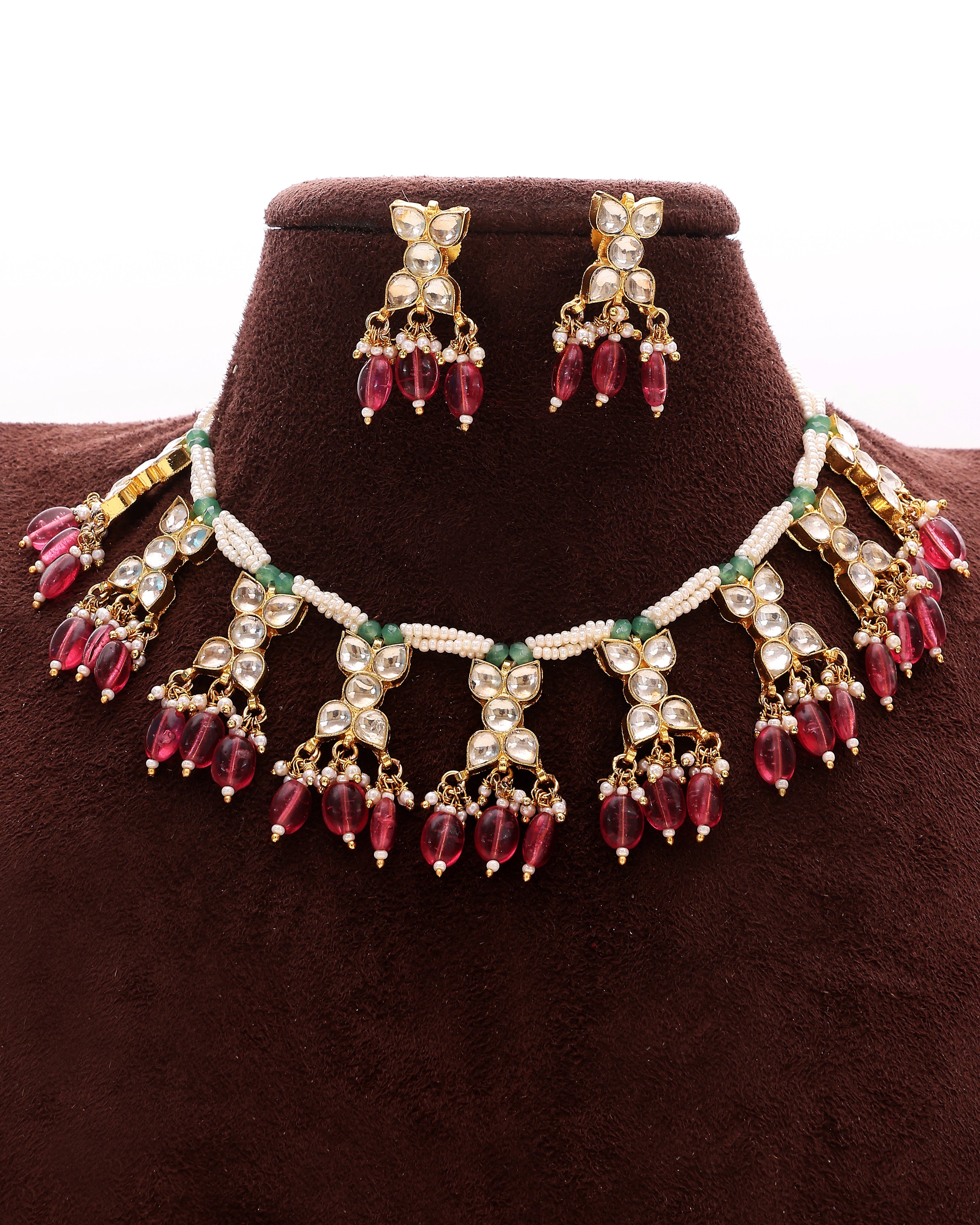 Jewelry set with necklace and earrings on a brown velvet stand