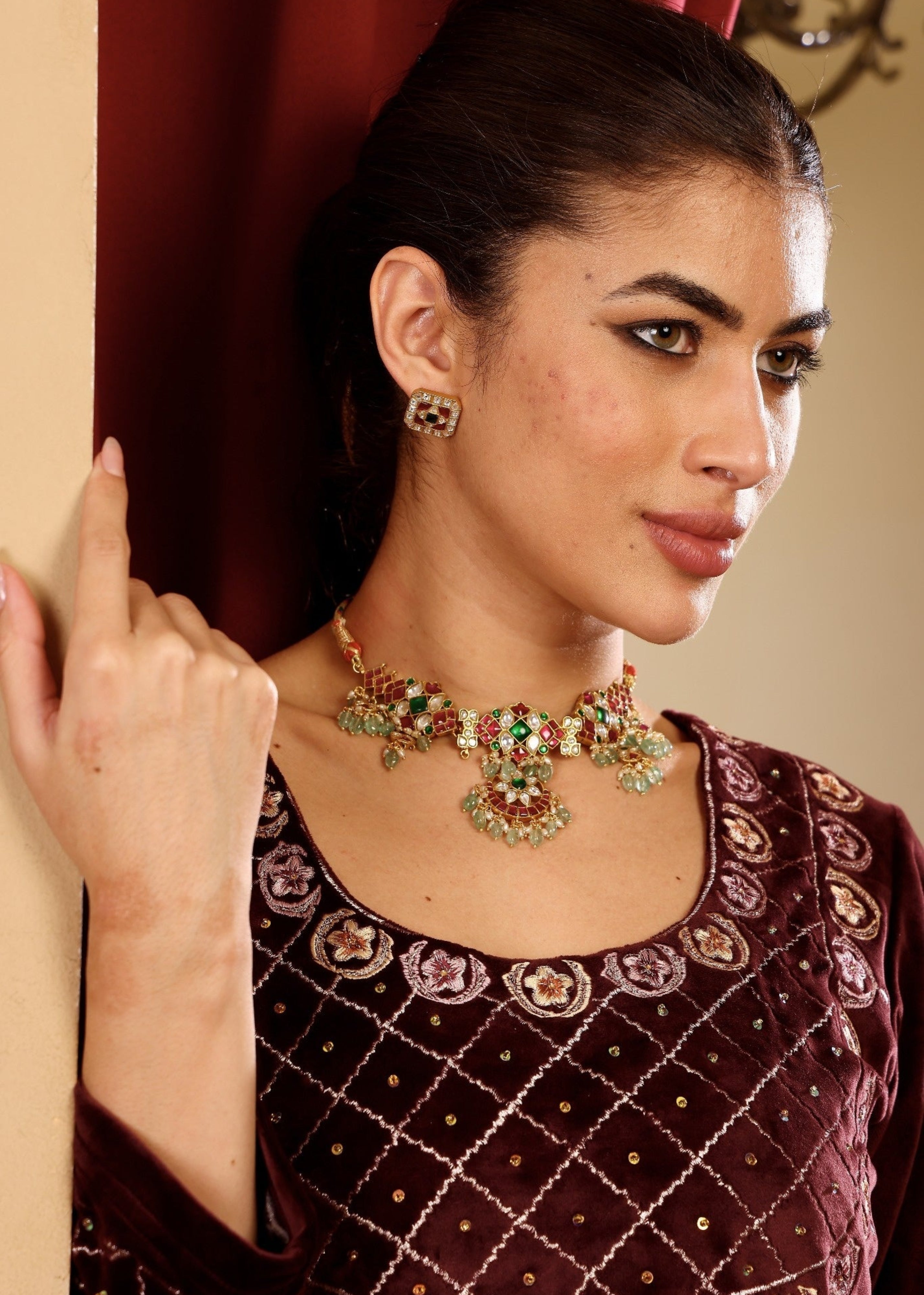 Woman wearing a decorative necklace and earrings indoors