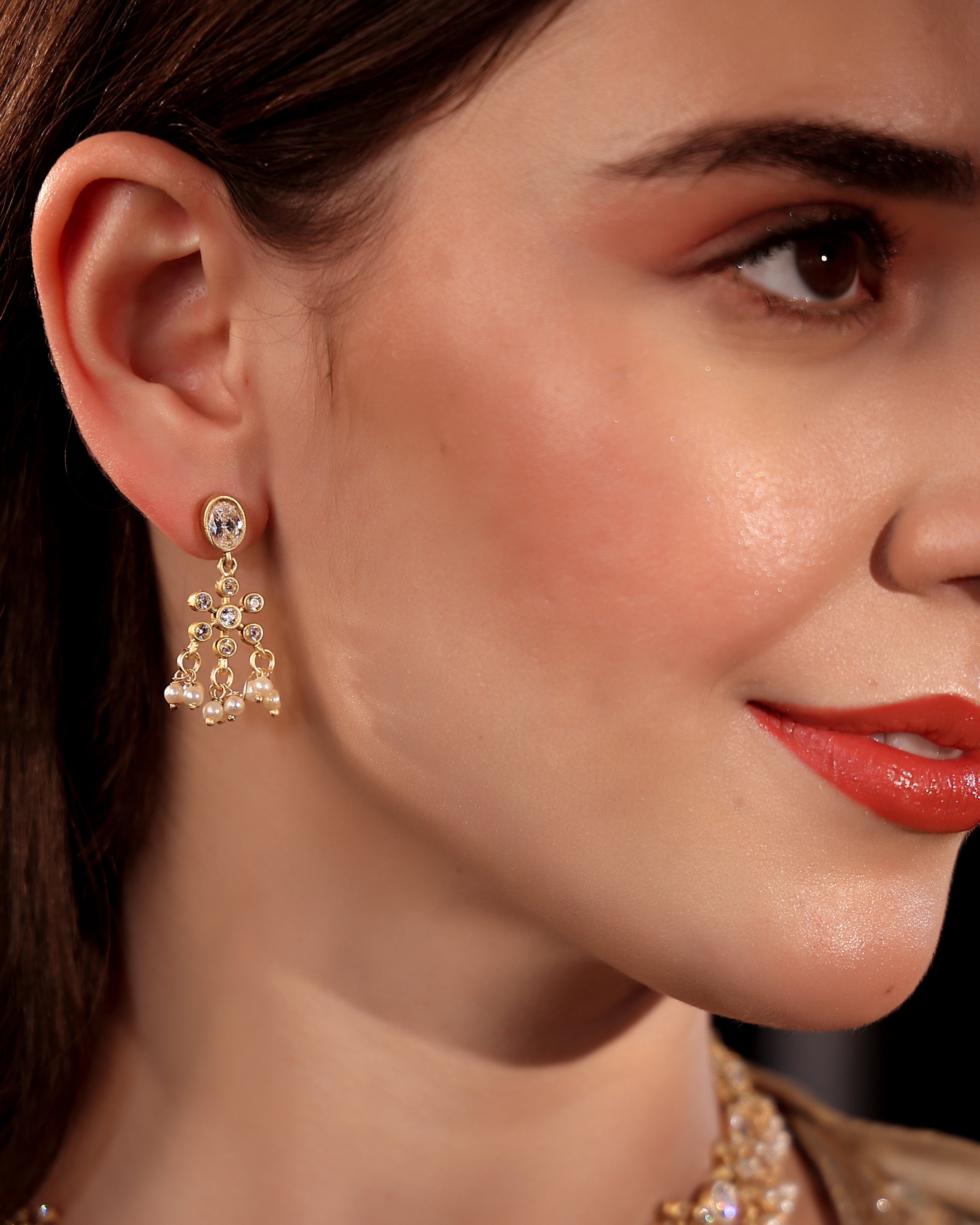 Close-up of a woman wearing elegant earrings with a blurred background