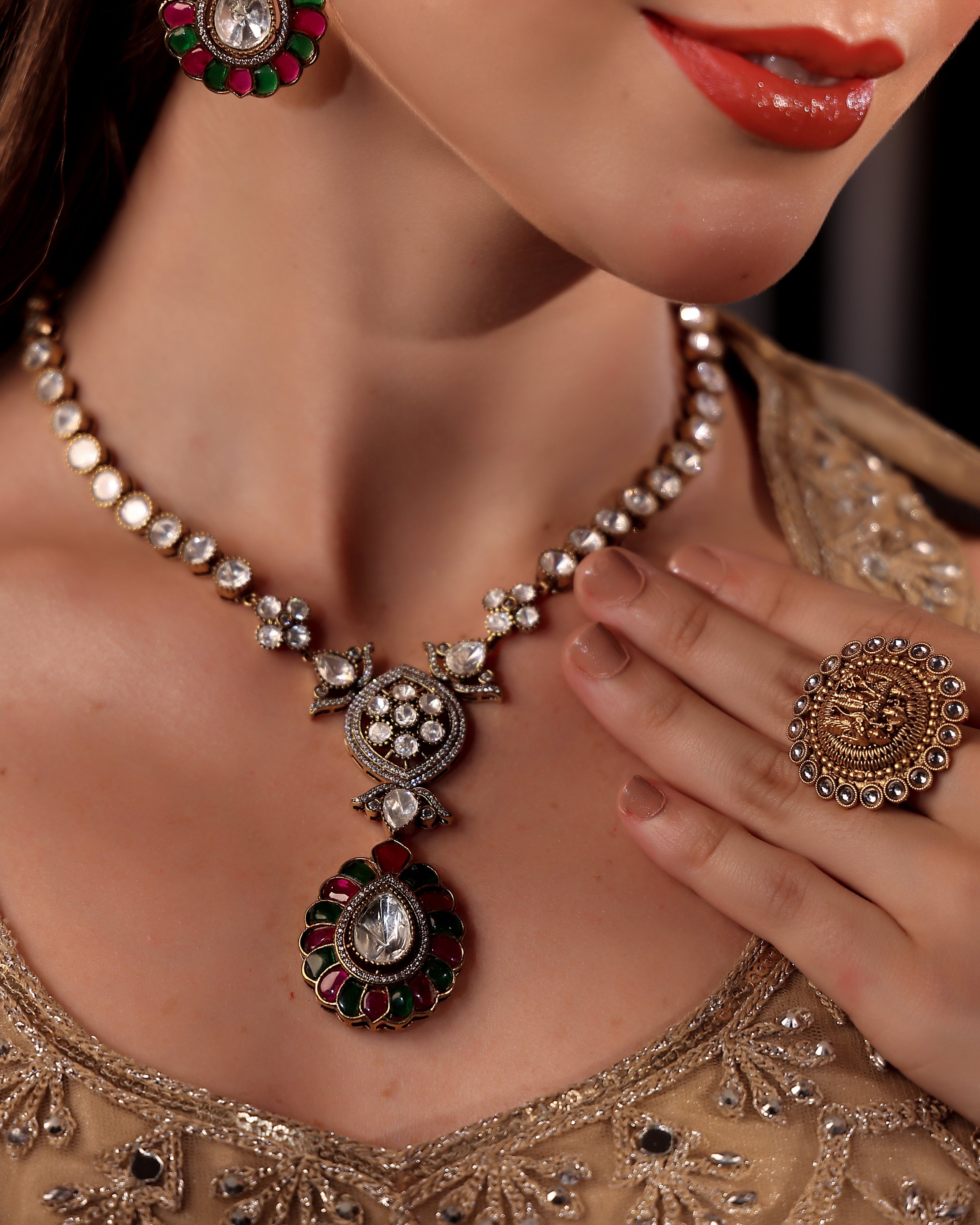 Close-up of a woman wearing an ornate necklace and earrings with intricate designs.
