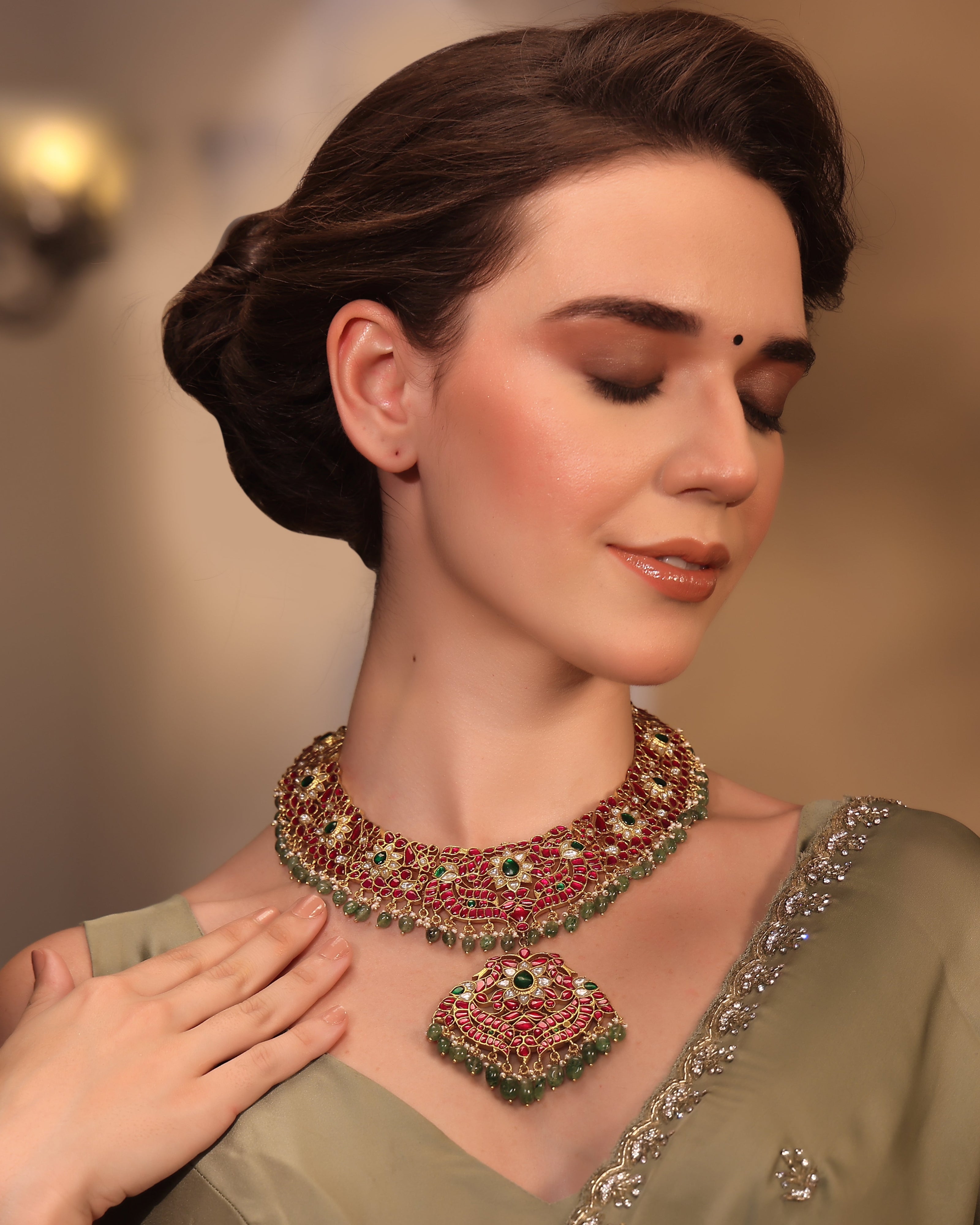 Woman wearing a traditional necklace and earrings with a blurred background