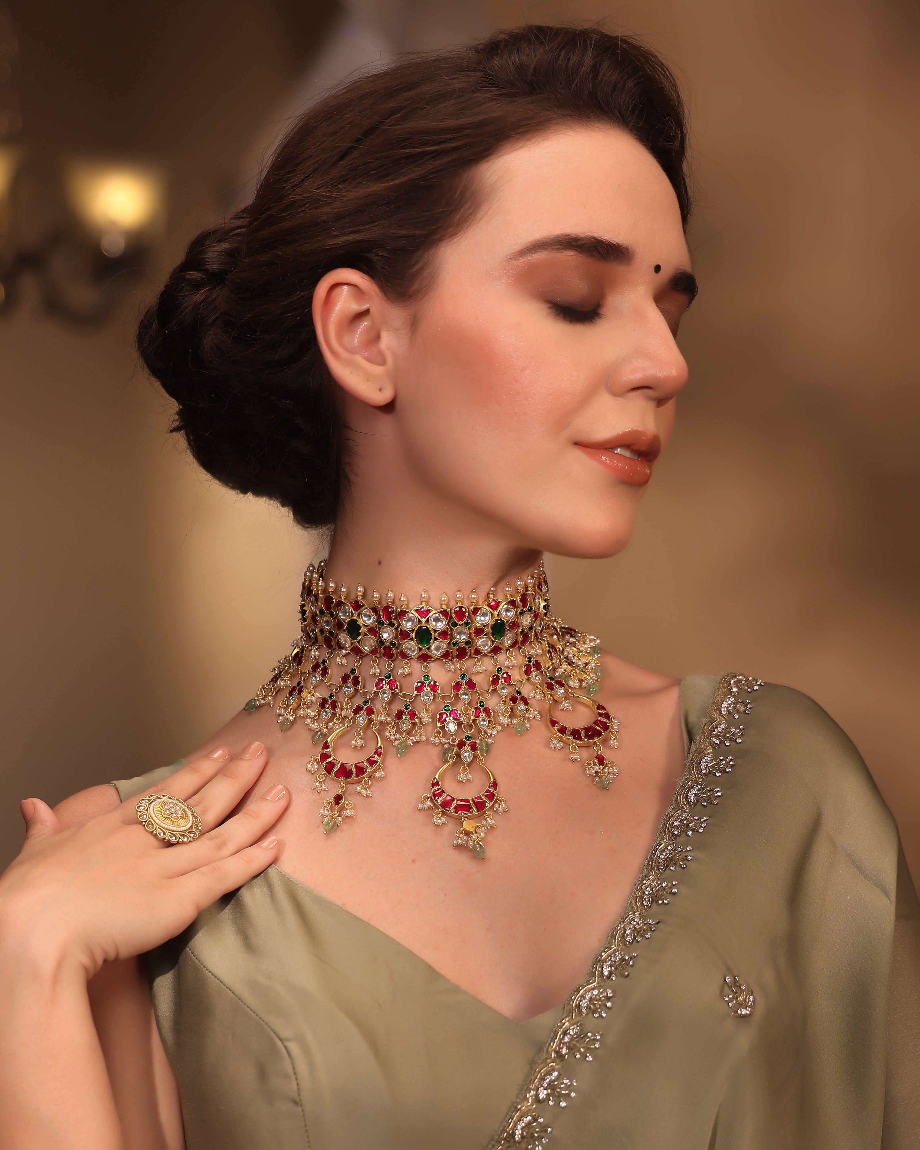 Woman wearing a traditional necklace and saree with a blurred background